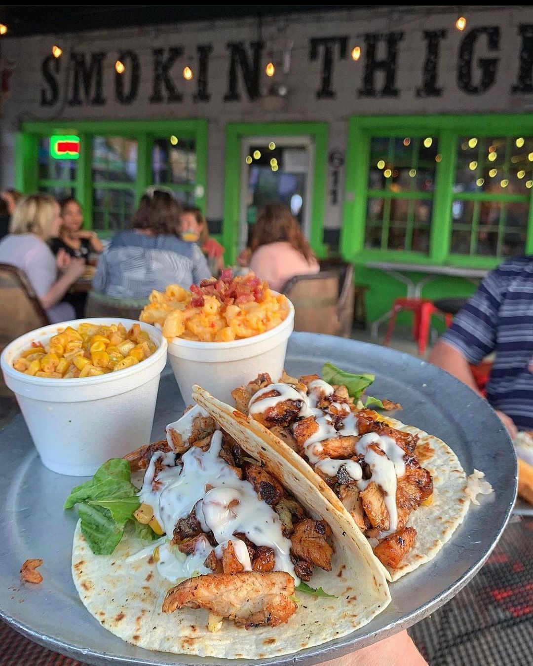 A plate of tacos, corn, and mac and cheese at Smokin Thighs in Nashville, TN. 