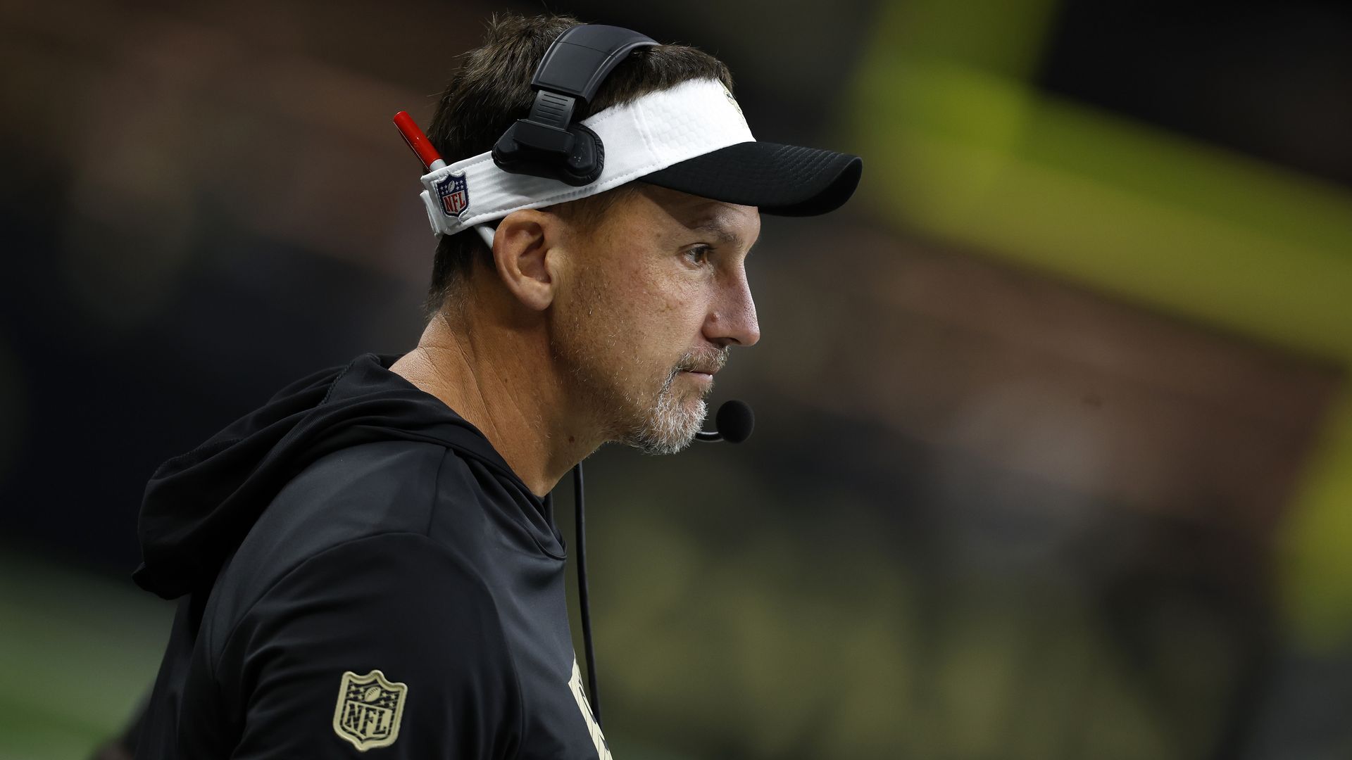 A photo of Dennis Allen during a game, shot in profile.