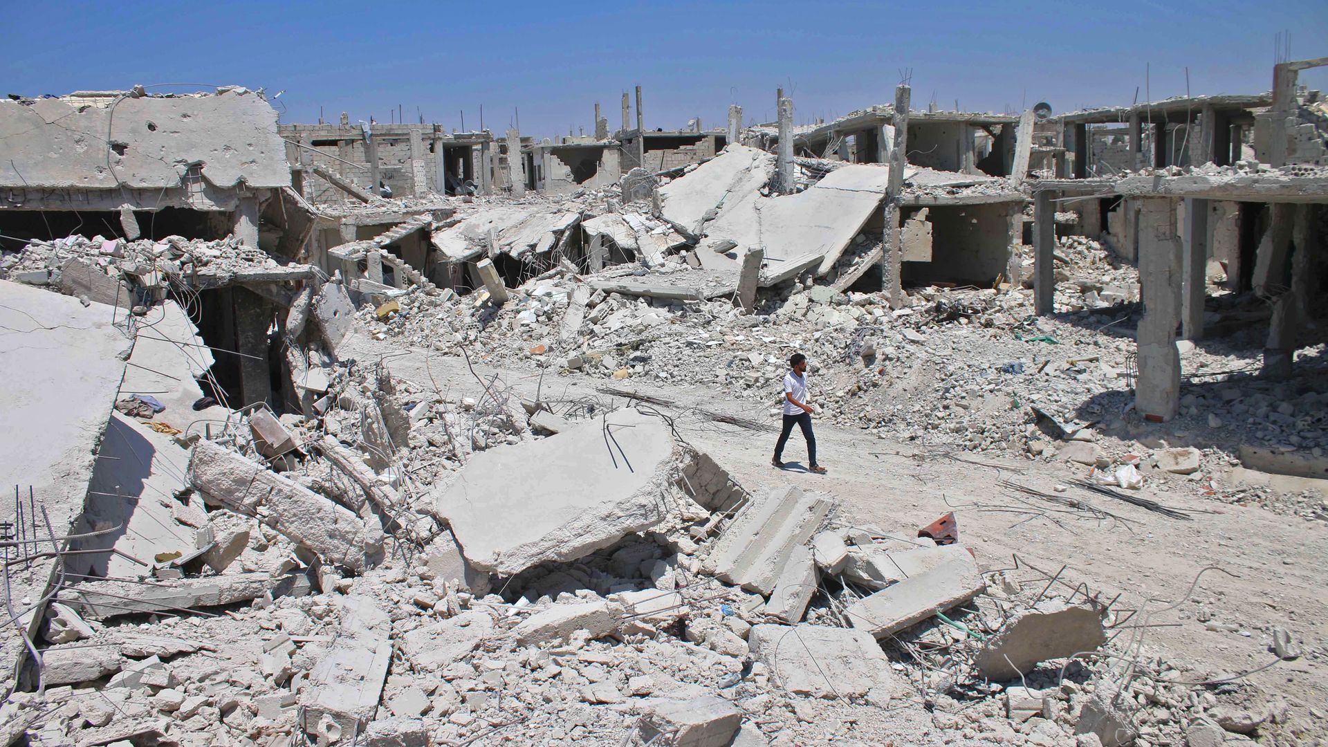 A Syrian man walks down the street in rebel-held Daraa