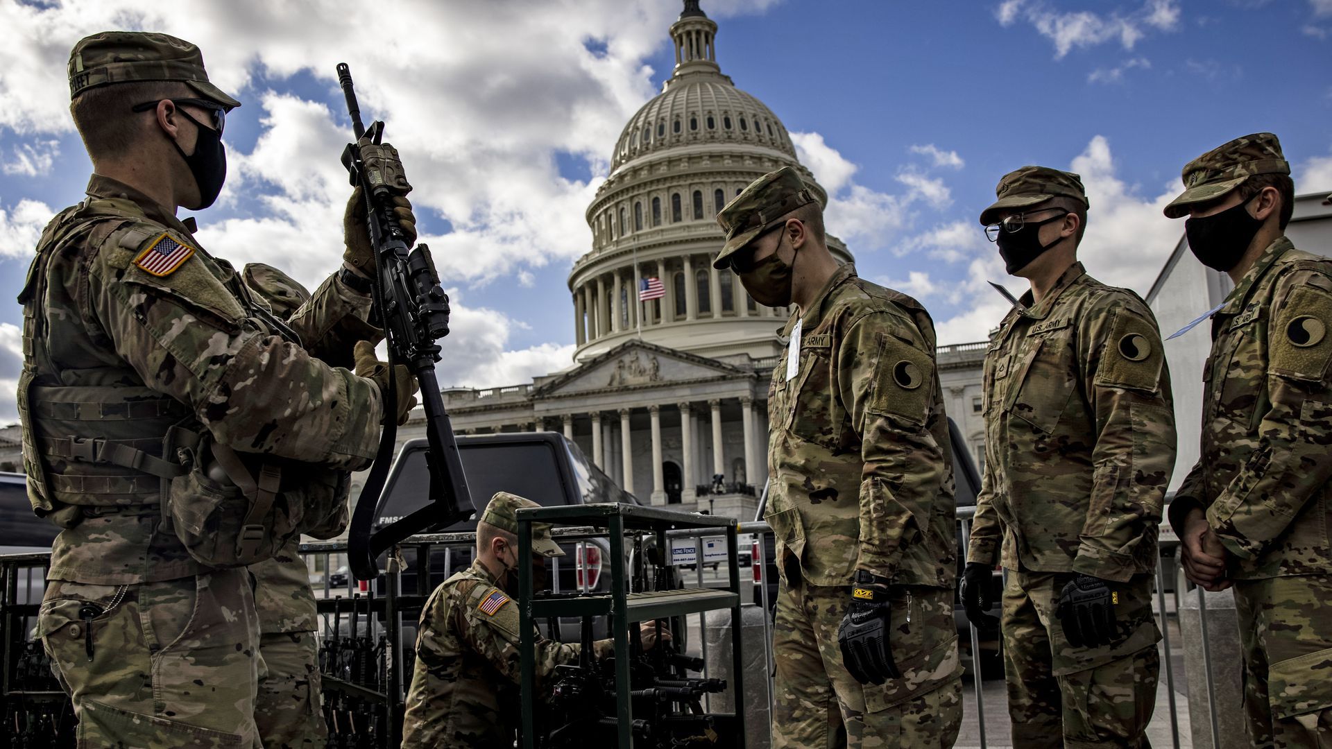 Virginia National Guard soldiers are issued their M4 rifles and live ammunition on the east front of the U.S. Capitol on Jan. 17.