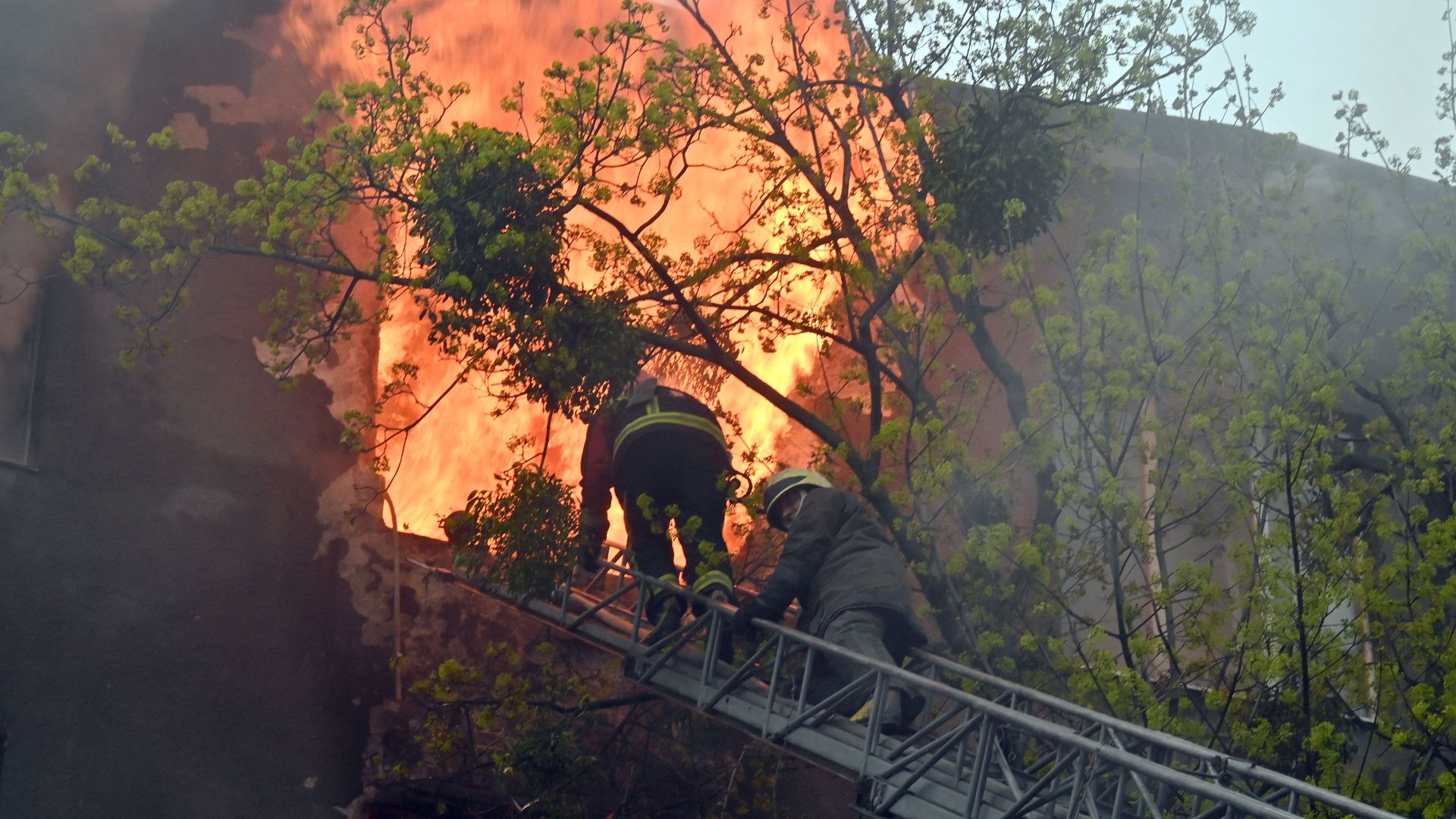  Firefighters try to extinguish a fire in a residential building following bombardment in central Kharkiv on April 17.