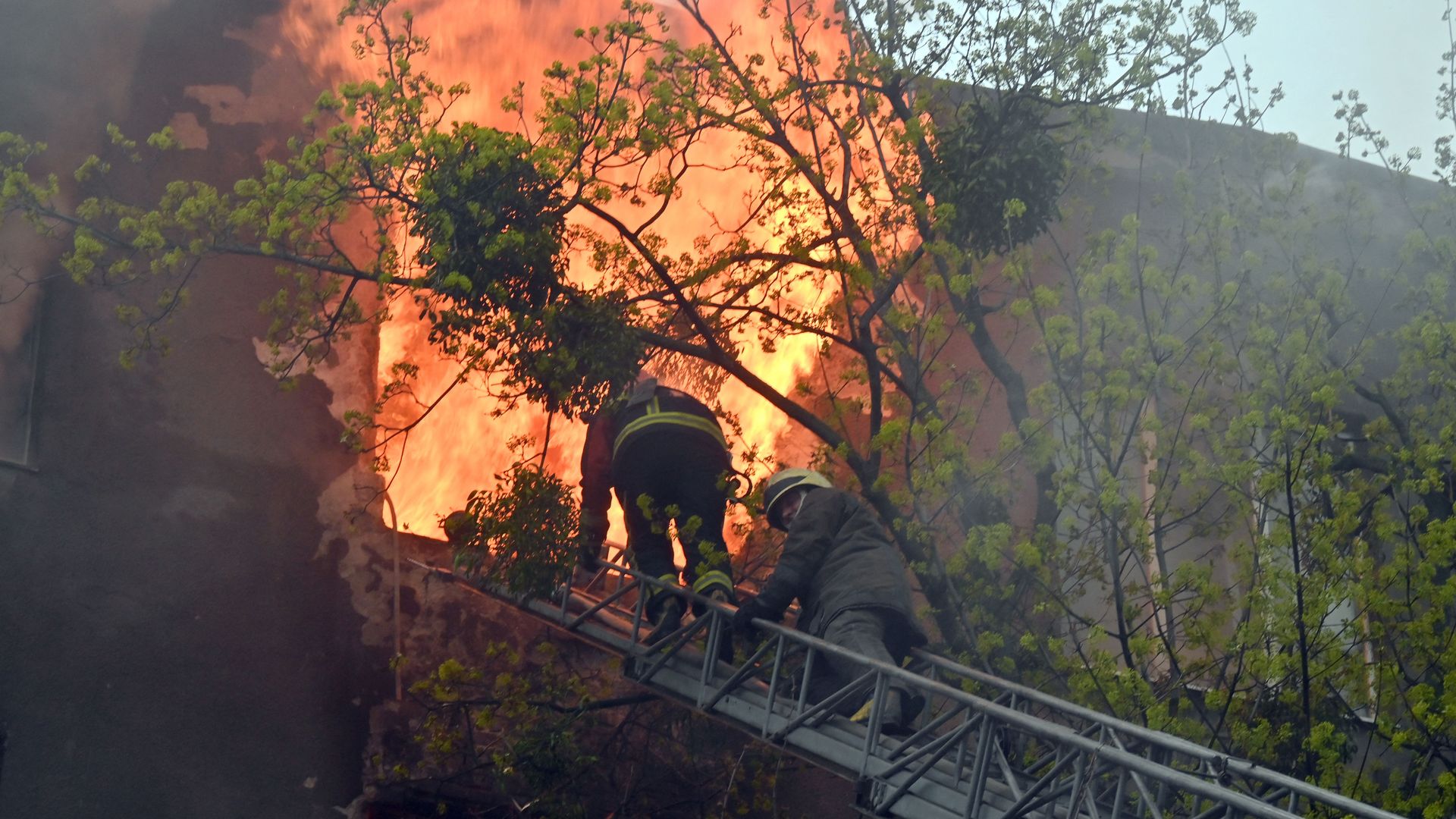 Firefighters try to extinguish a fire in a residential building following bombardment in central Kharkiv on April 17.