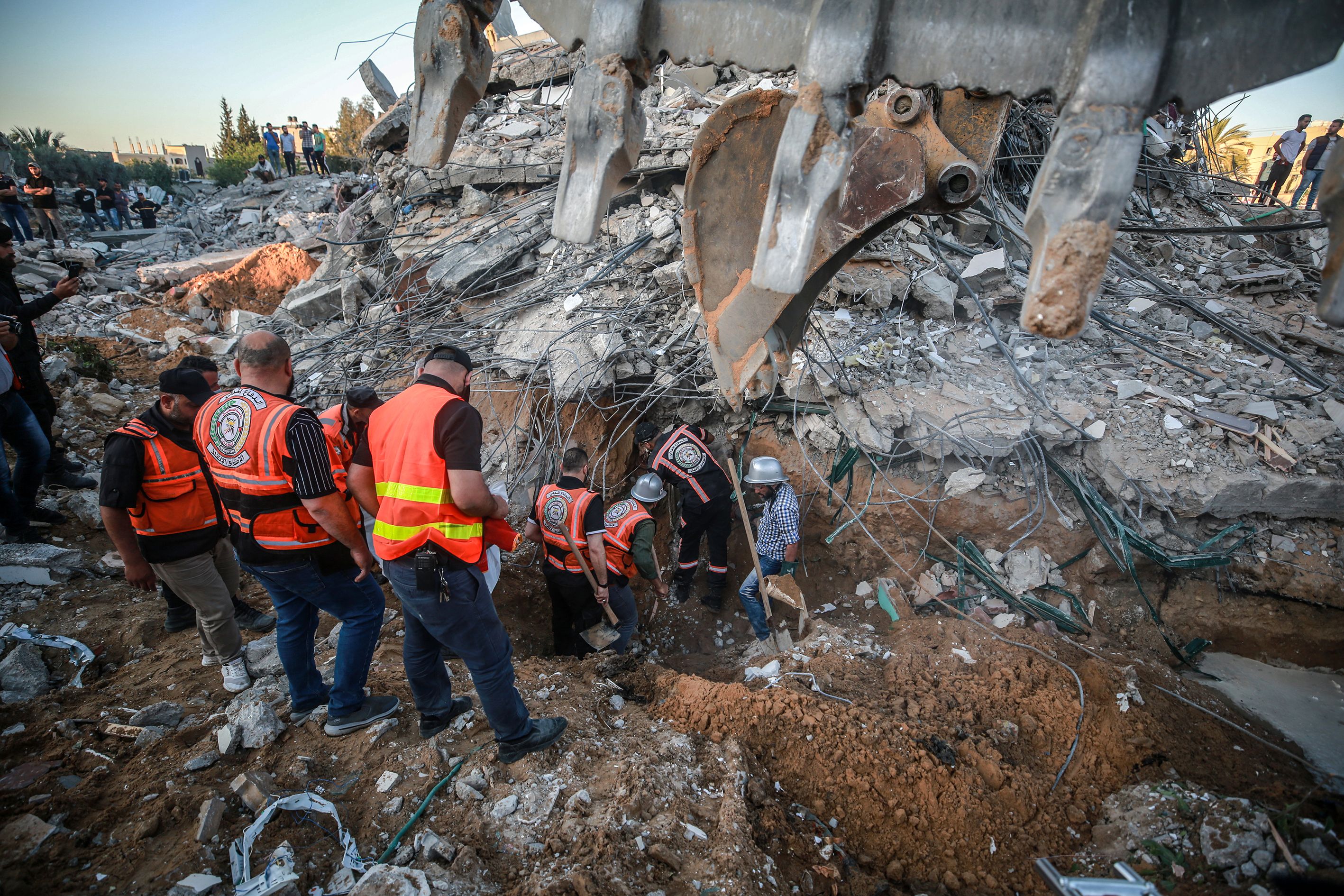 Palestinian civil defense teams take part in rescue works at the rubbles of a building belonging to a Palestinian family after Israeli airstrikes in Gaza on May 13.