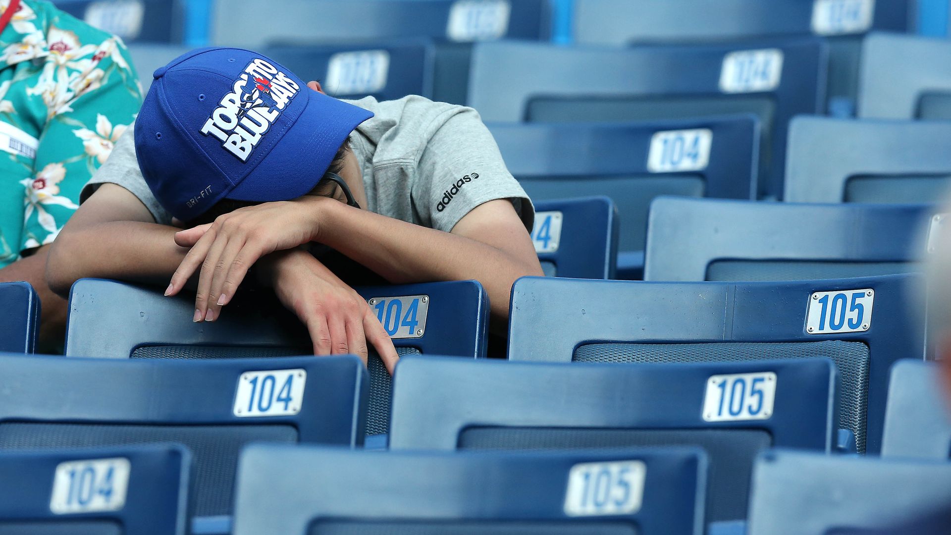 Photo of a sleeping fan at a Toronto Blue Jays baseball game