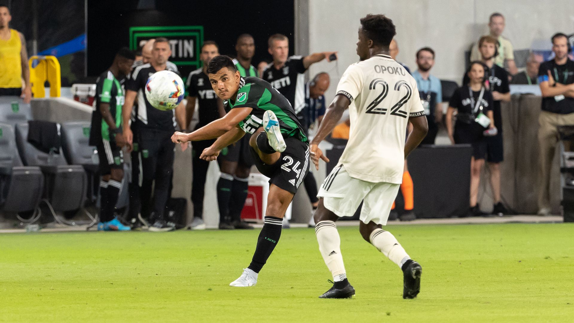 An Austin FC player strikes the ball.