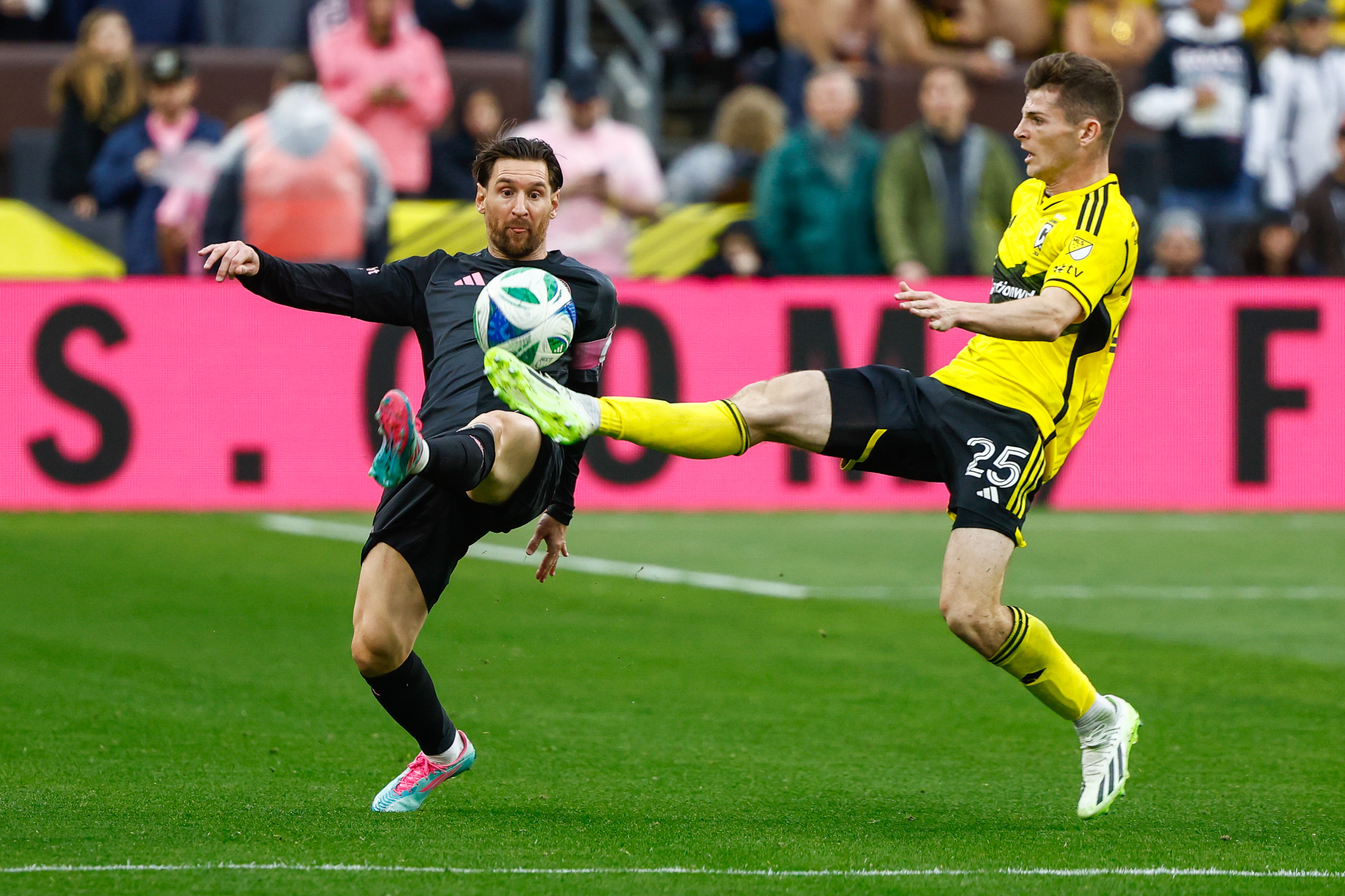 Lionel Messi and Sean Zawadzki battle for a bouncing ball