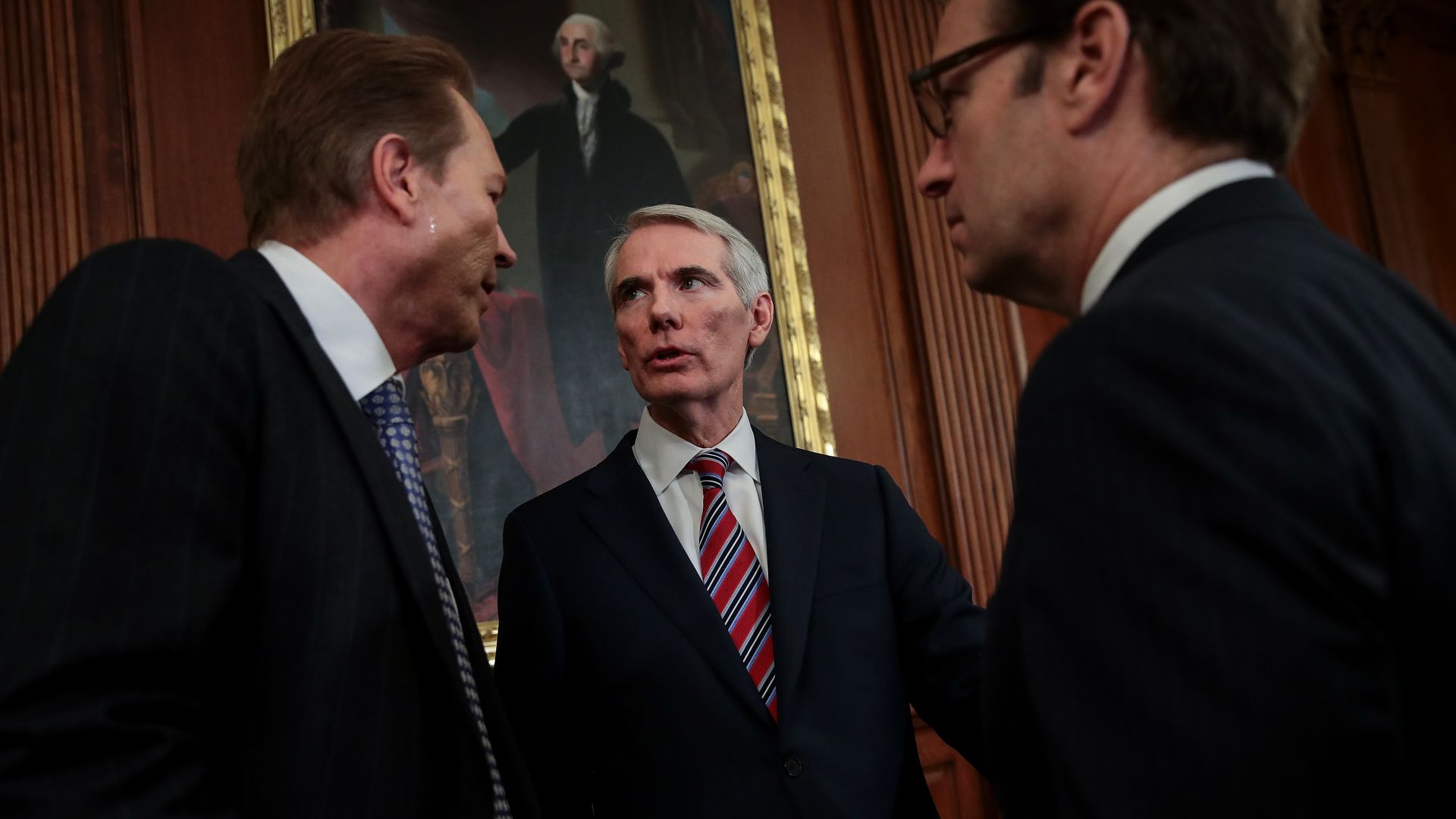 Senator Rob Portman speaks with two men