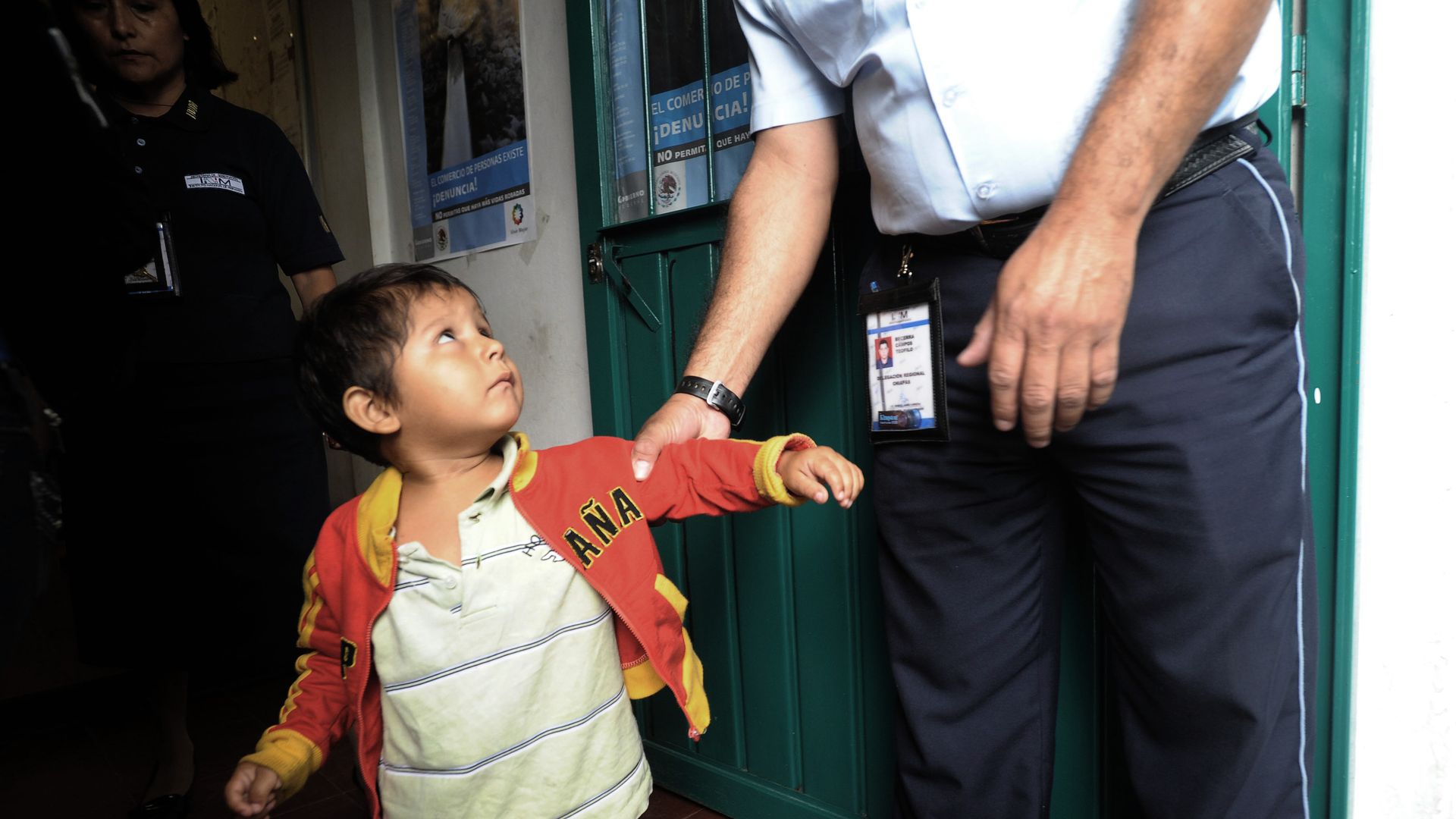 An immigrant child with a police officer. 