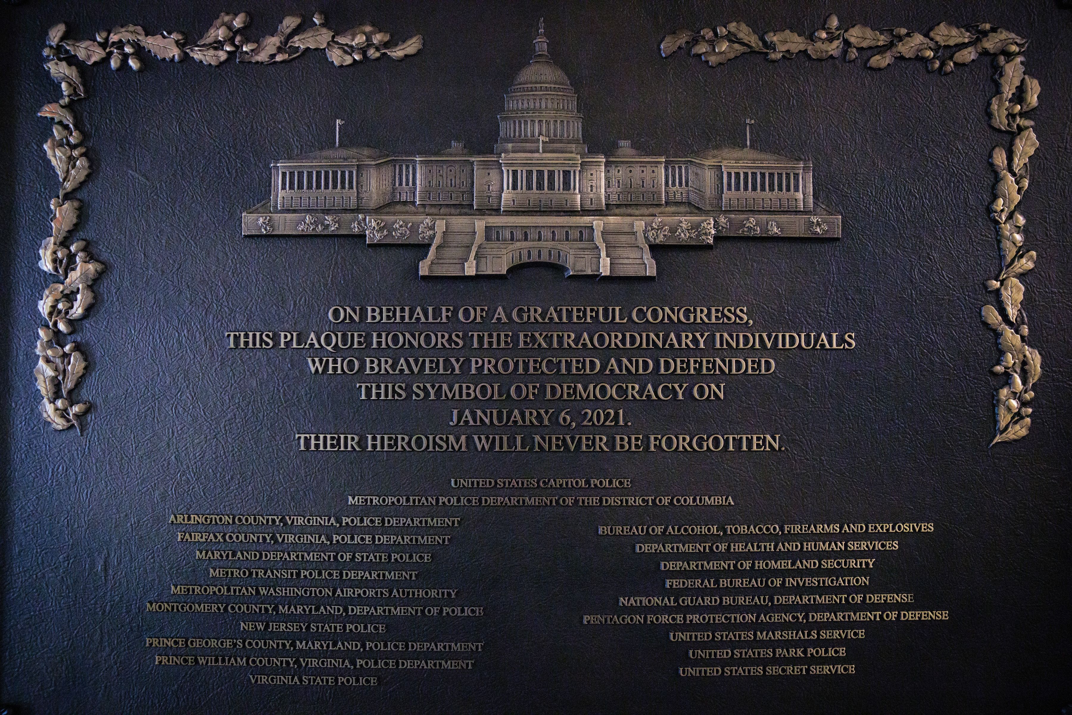 WASHINGTON, DC - MARCH 7: A plaque honoring the various law enforcement organizations that responded to the January 6th Insurrection is seen mounted next to one of the primary entrances that saw clashes between law enforcement and the insurrectionists on March 7, 2026 in Washington, DC. The plaque w