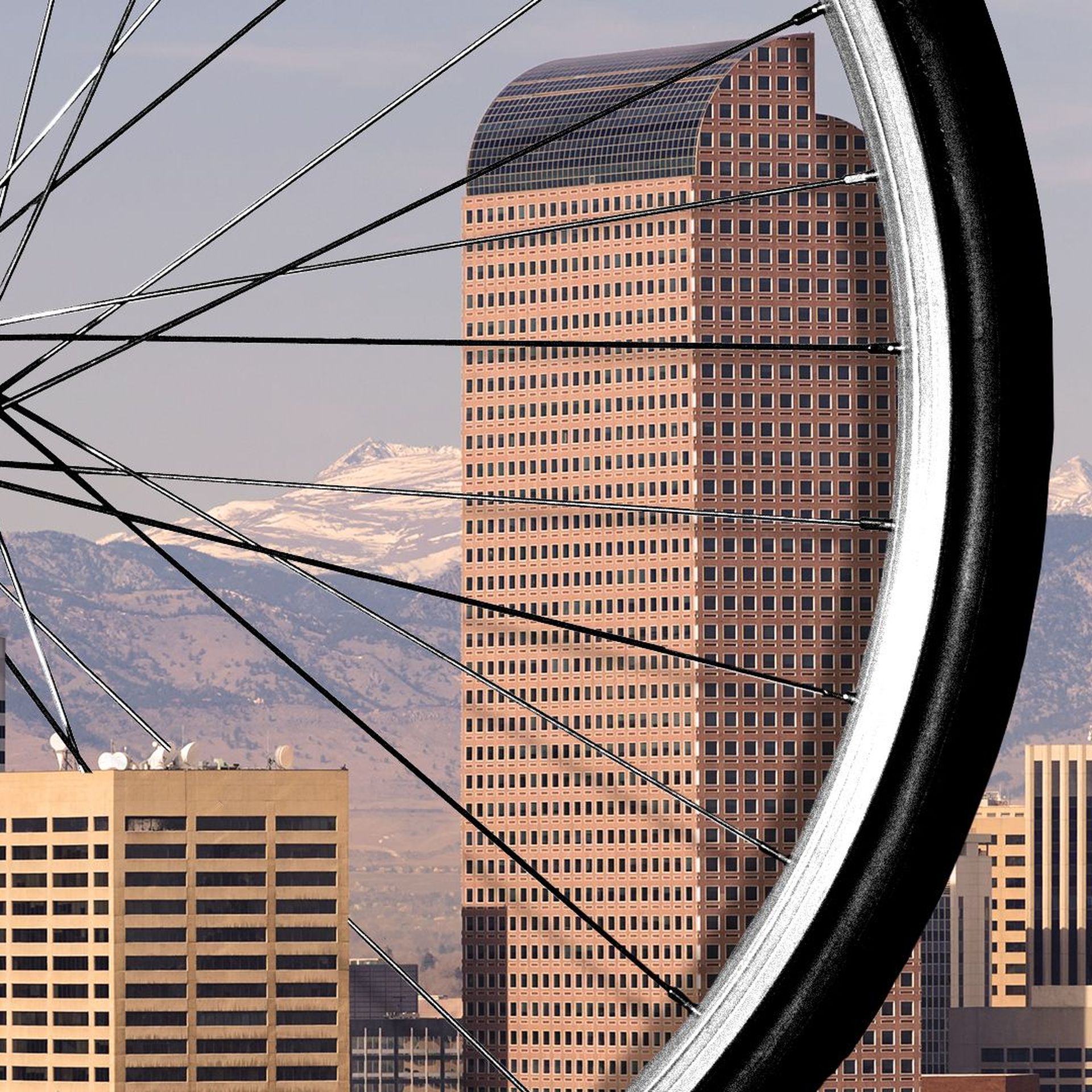 Illustration of a giant bike wheel in downtown Denver. 