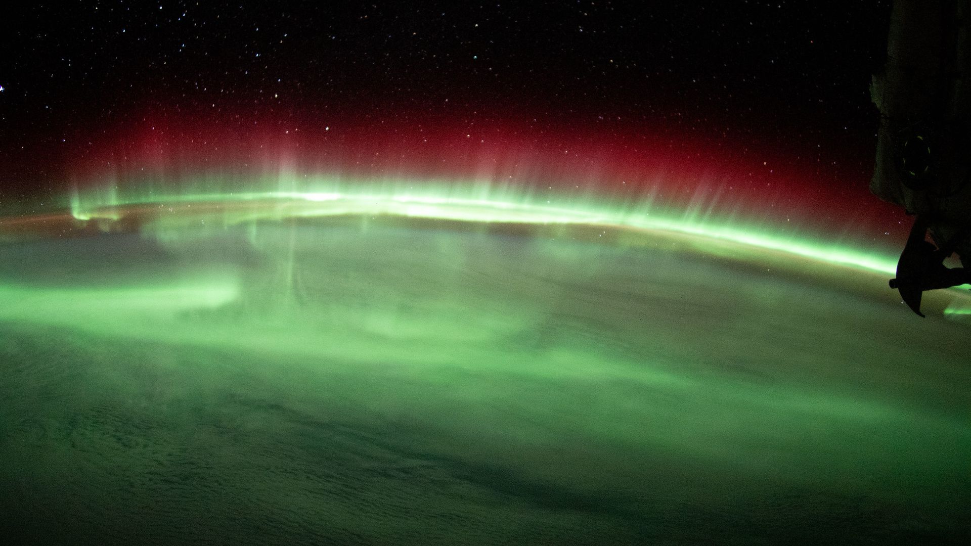 The green and red curtains of the auroras seen from space 