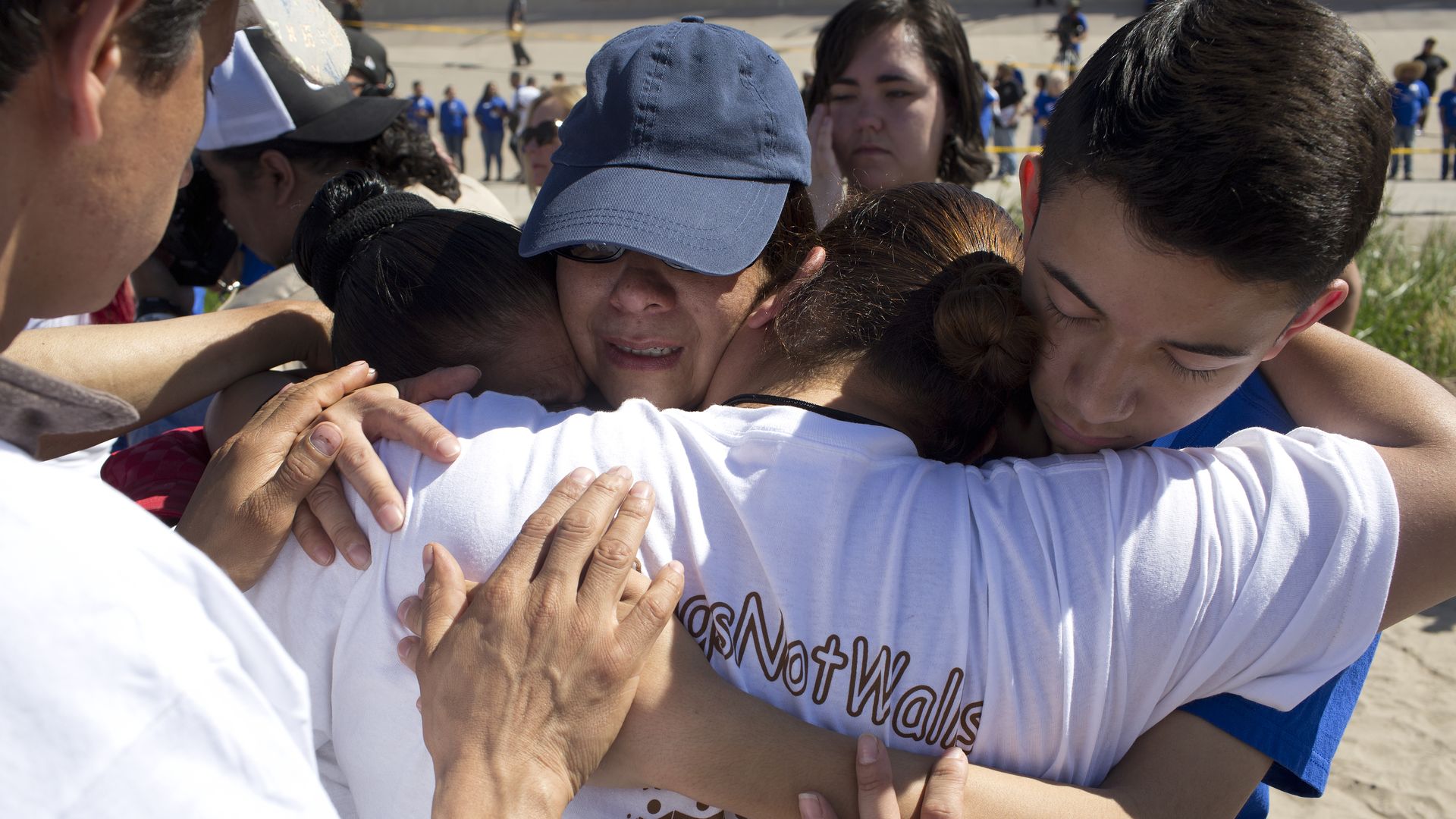 Immigrant families hugging as they're reunited after being separated