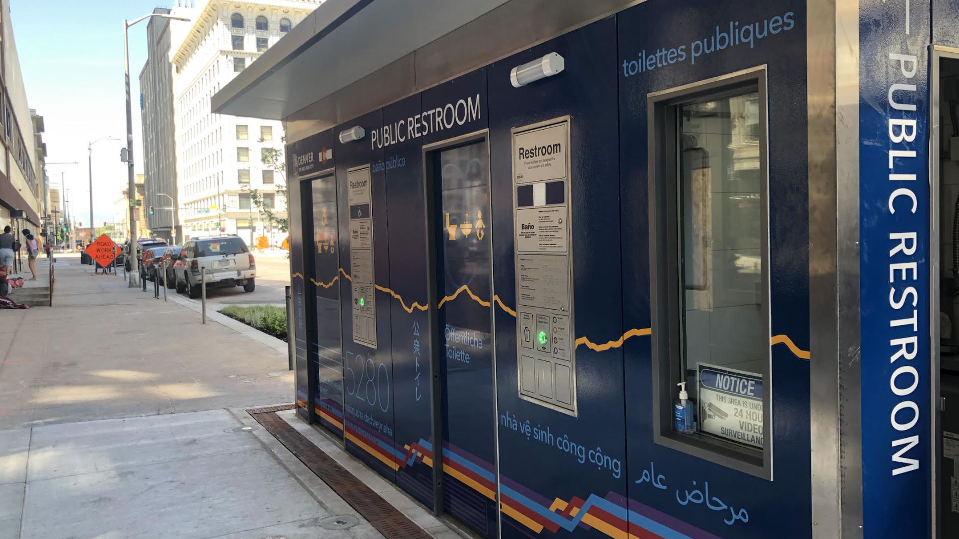 A photo of the blue public restroom on the curb