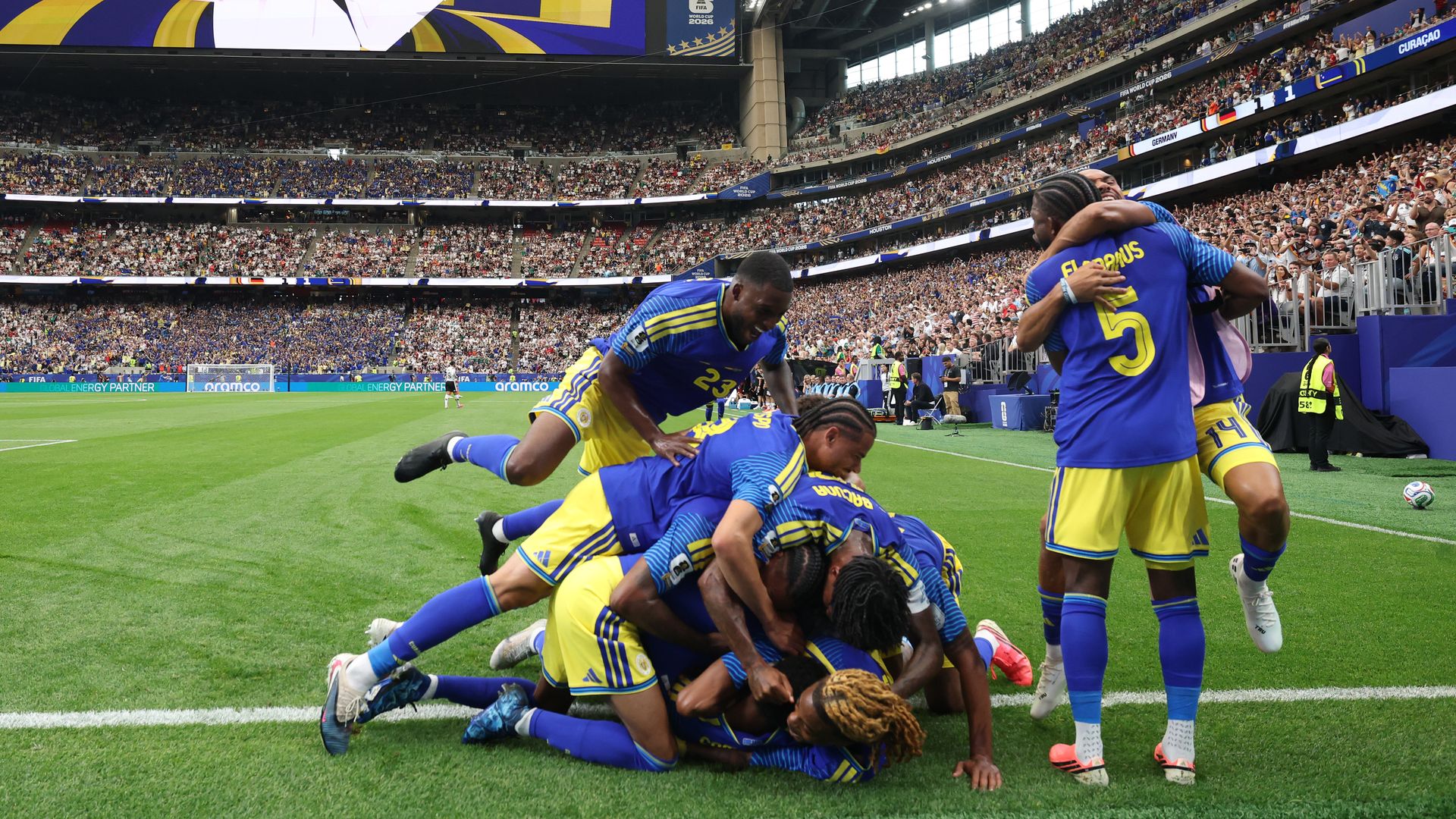 Livano Comenencia #8 of Curacao celebrates with teammates after scoring the team's first goal during the FIFA World Cup 2026 Group E match between Germany and Curacao at Houston Stadium on June 14, 2026 in Houston, Texas. 