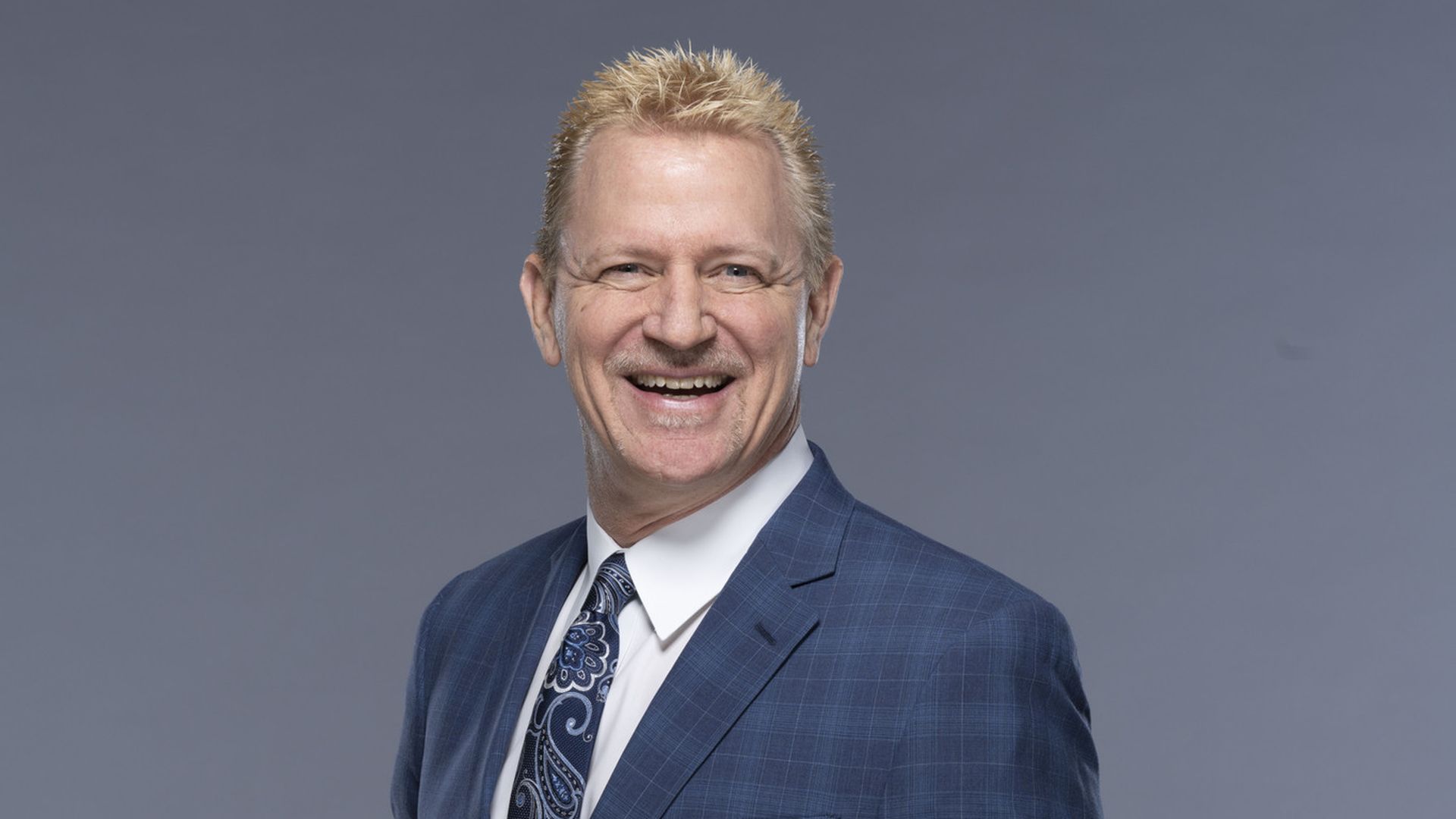 Former wrestler Jeff Jarrett poses for a portrait in a blue suit.