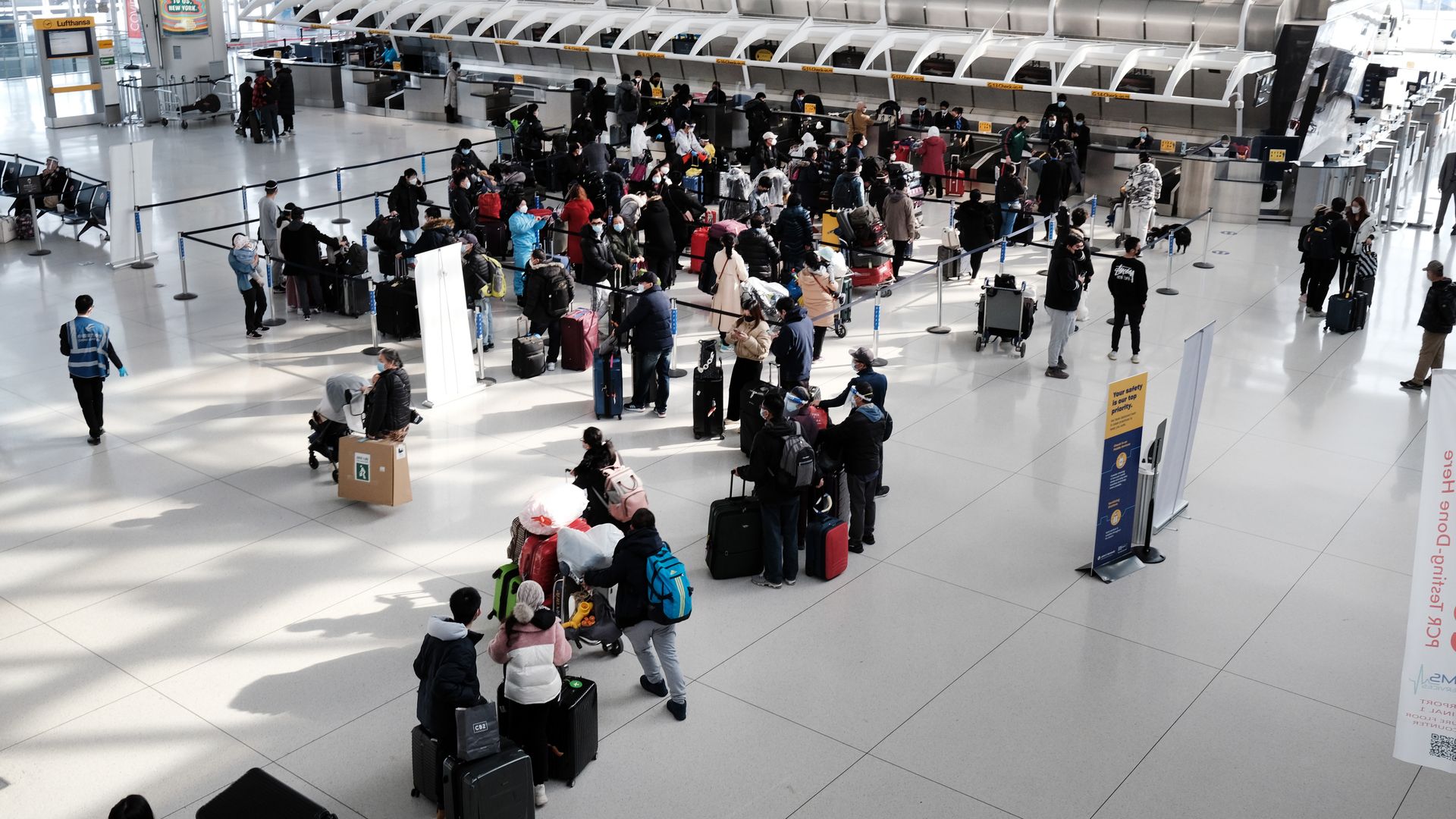 Image of people waiting at the ticket area for JFK International Airport.