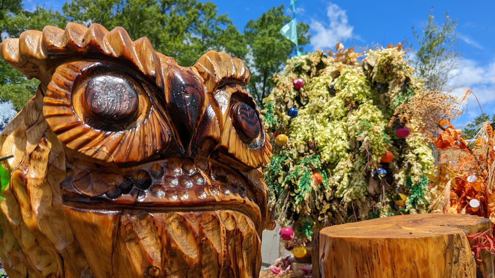 Photo of an owl sculpture carved out of wood. 
