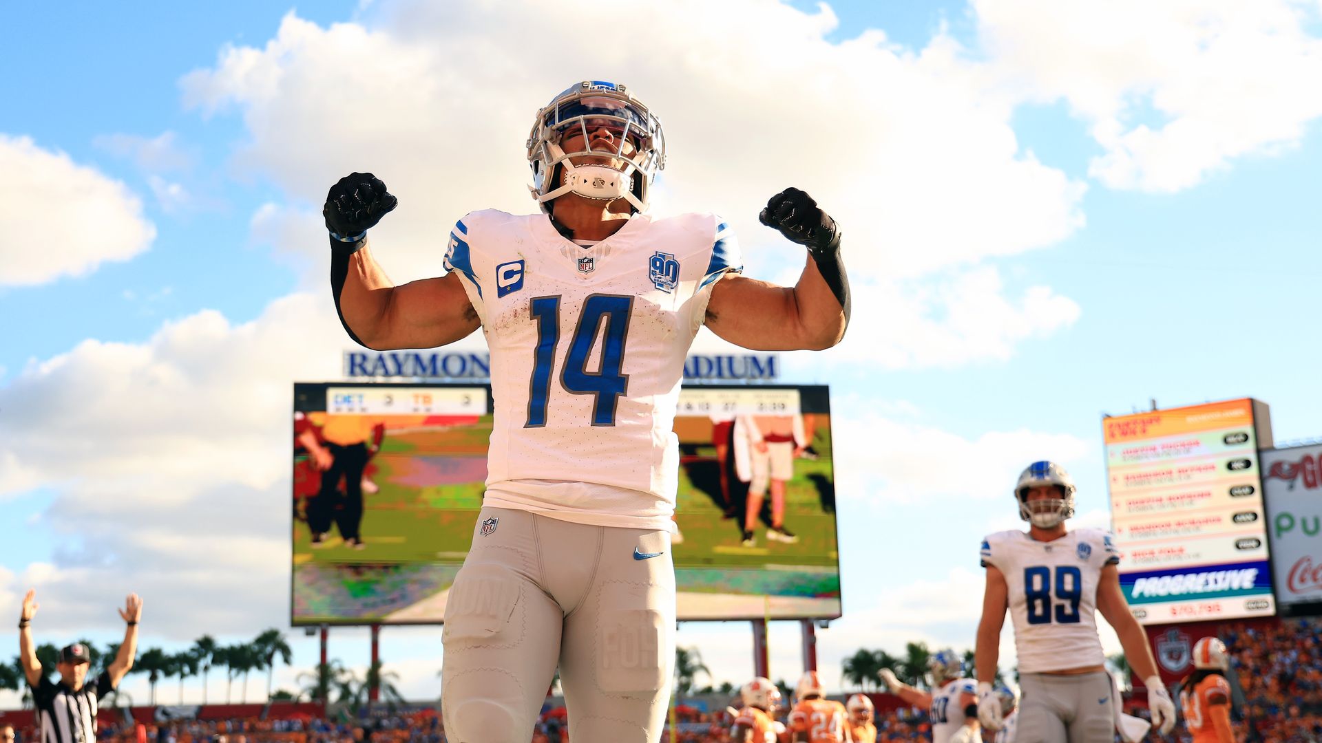 Lions wide receiver Amon-Ra St. Brown flexes after scoring a touchdown 