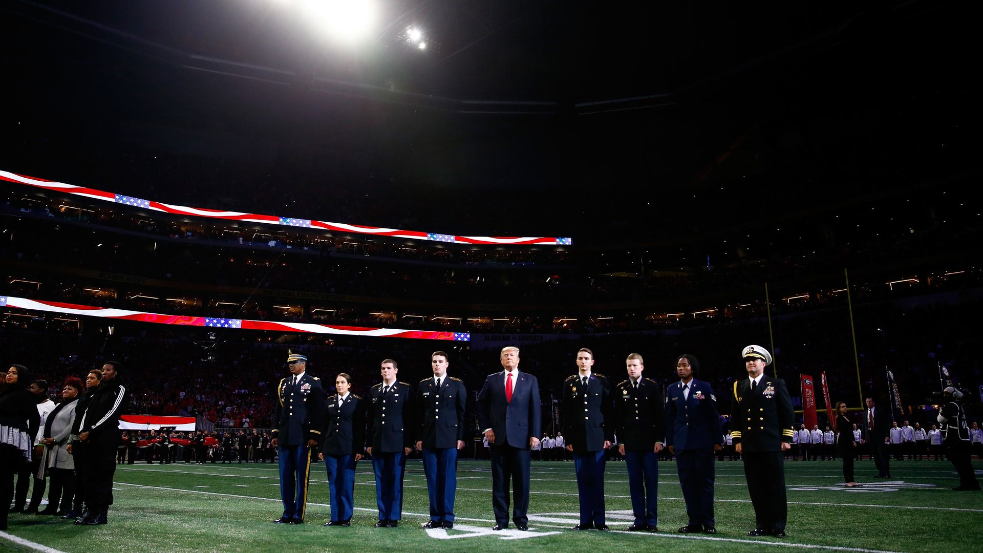 President Donald Trump on field during the national anthem prior to the CFP National Championship.