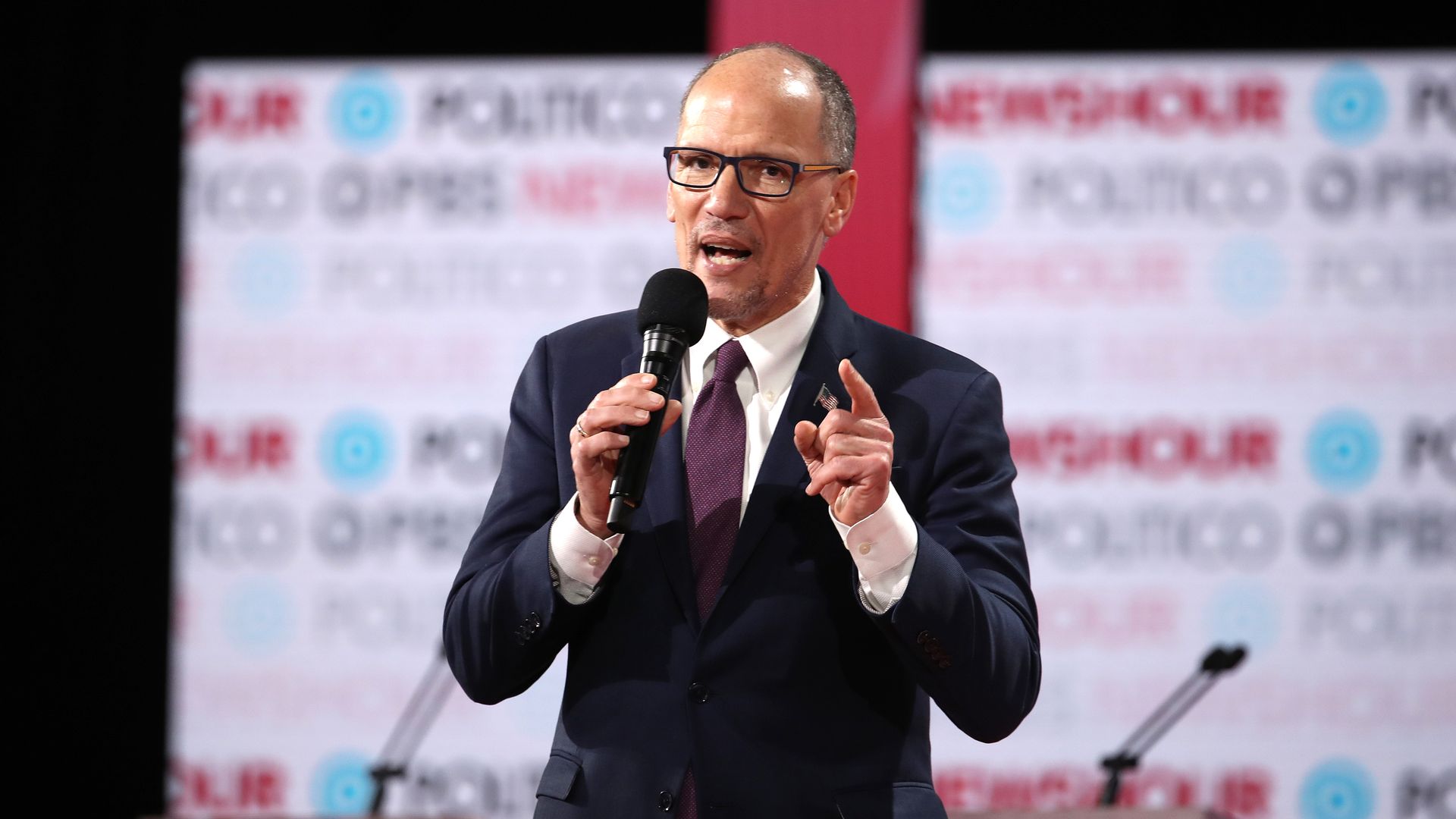 Tom Perez speaks with a microphone.