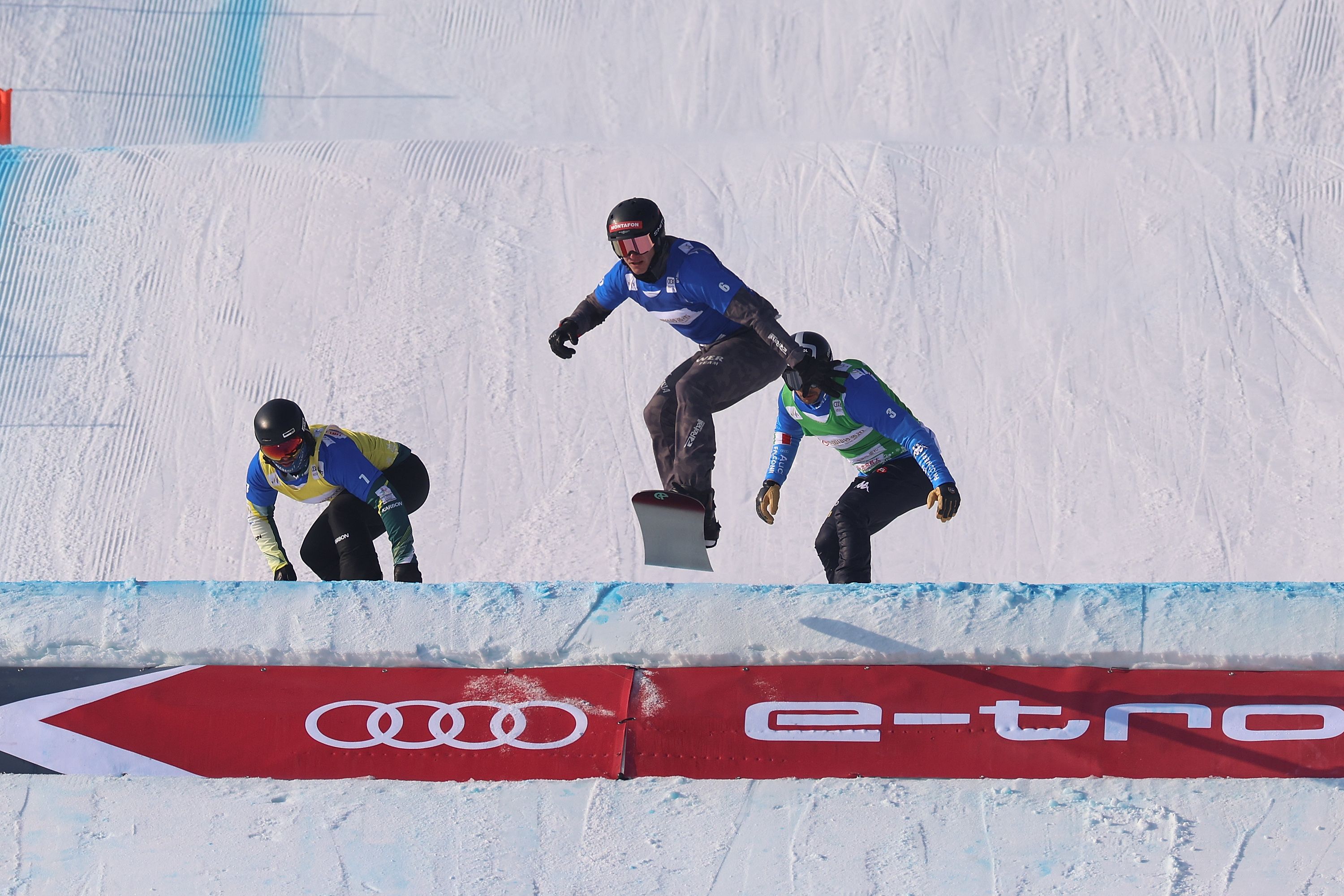 Adam Lambert of Austria , Mick Dierdorff of the United States and Martin Noerl of Germany compete in the Men's Snowboard Cross