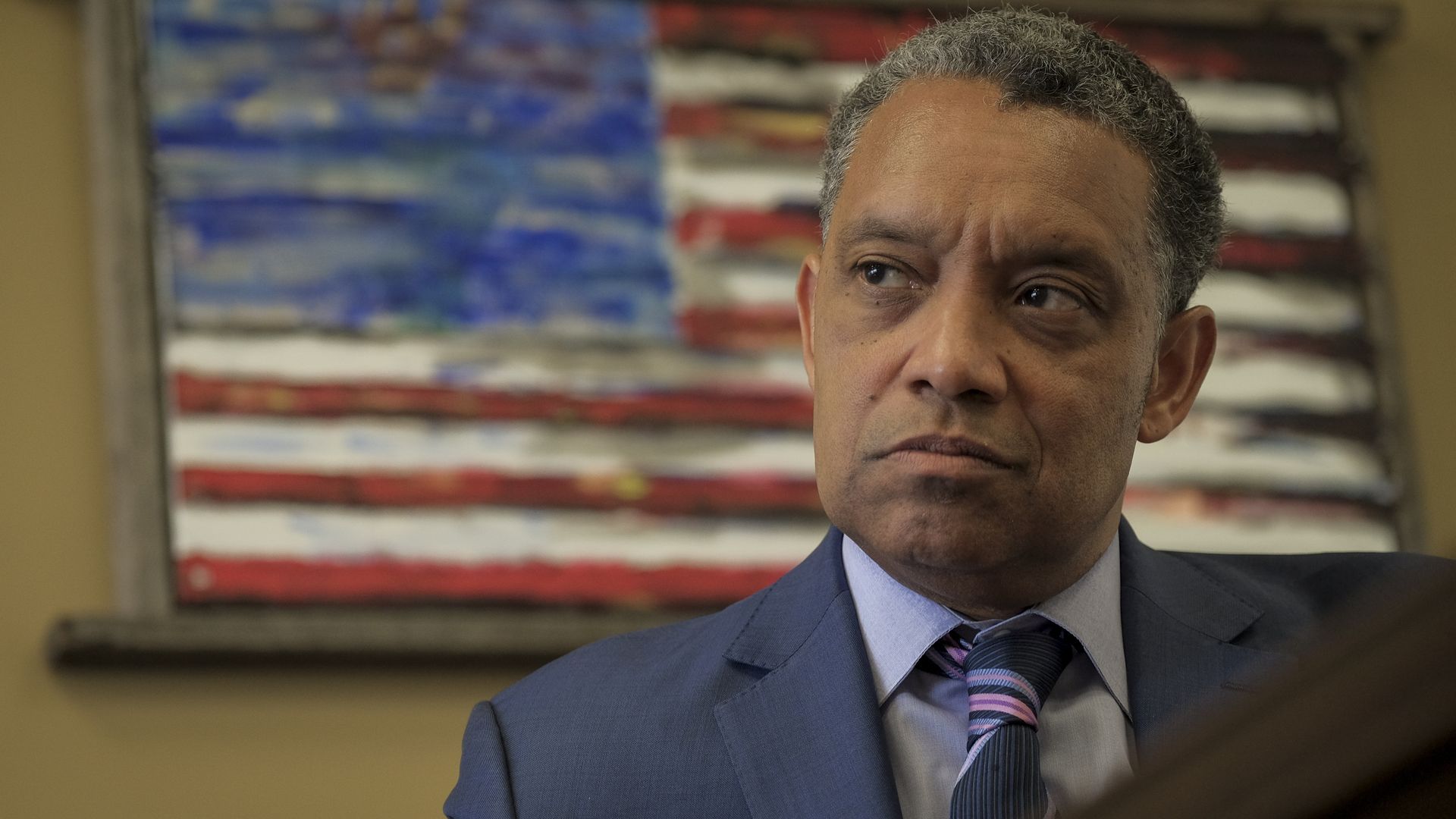 Washington, D.C. Attorney General Karl Racine sits for an interview in his office in front of an American flag in March 2019. 