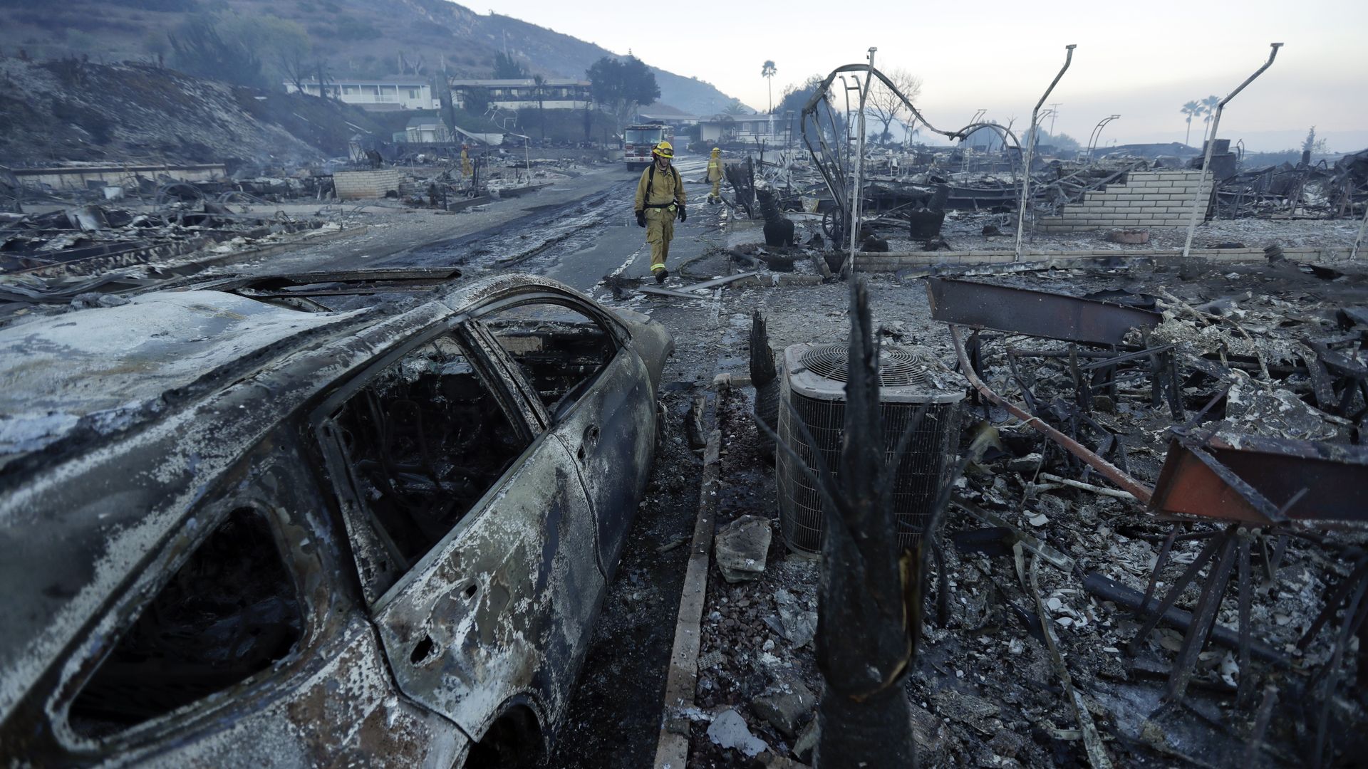 Fire crews search for hot spots among destroyed homes in the Rancho Monserate Country Club community.