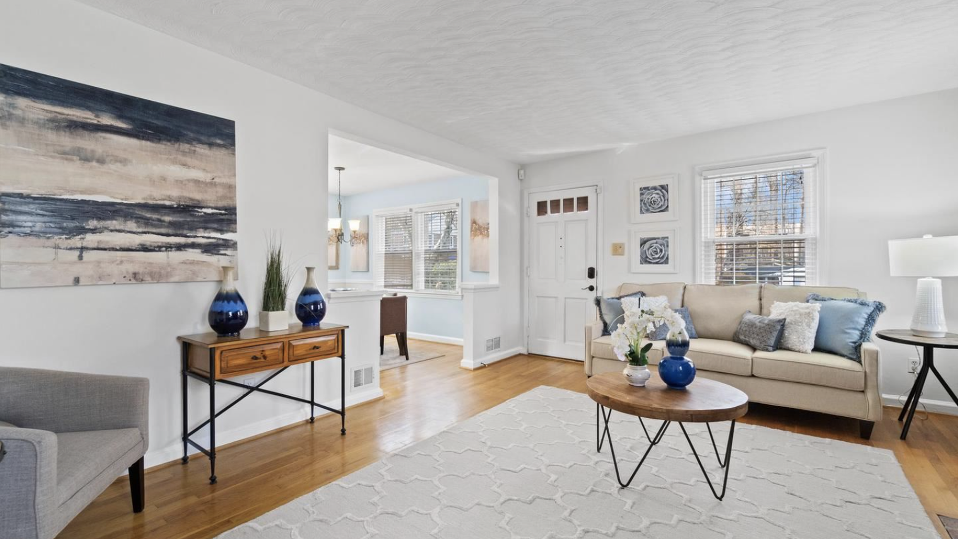 The inside of a decorated living room in a single family home.