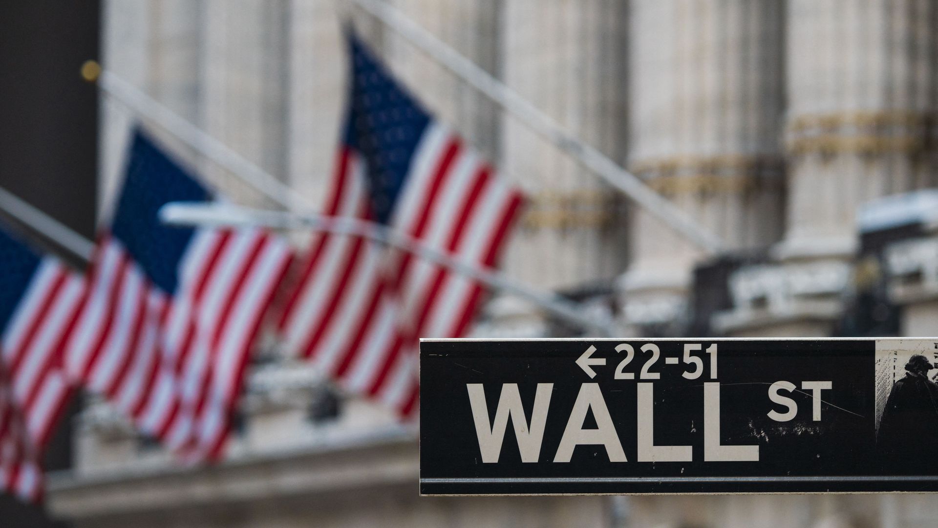 A Wall St sign hangs at the New York Stock Exchange.