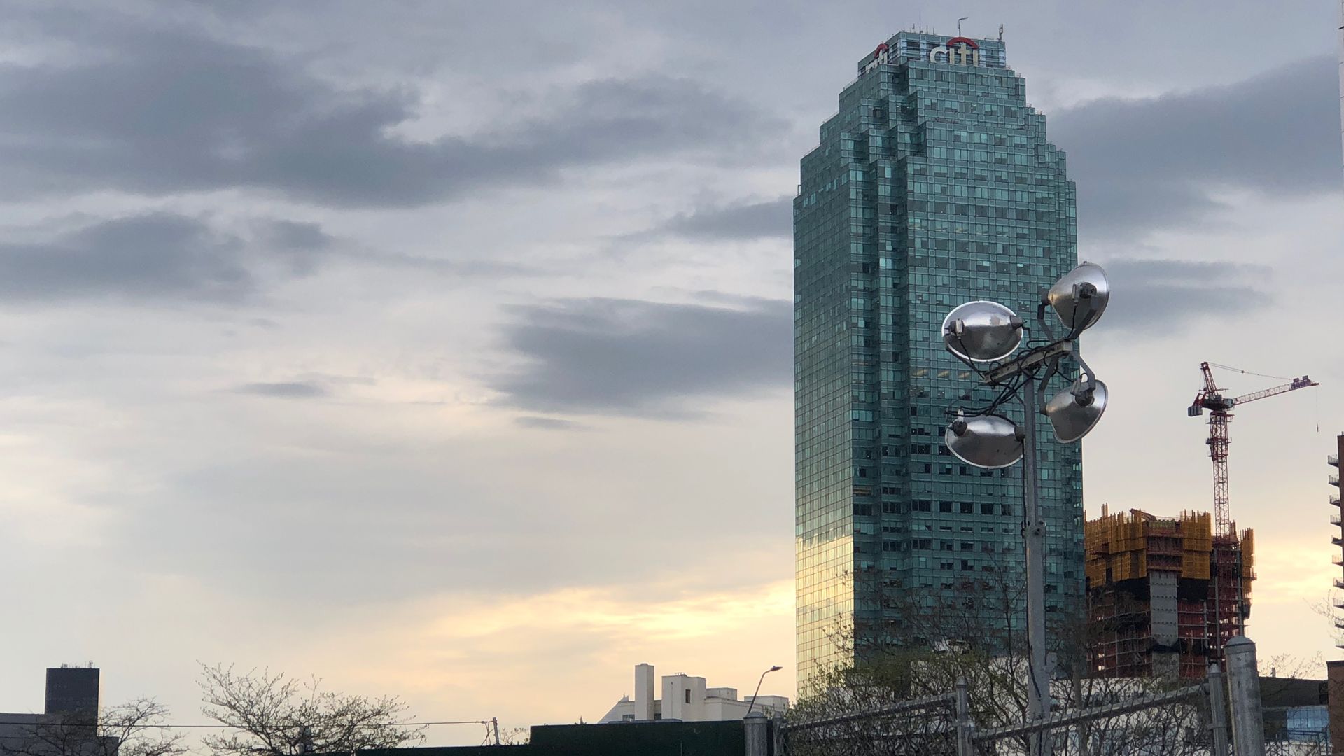 A glass skyscraper against a sunset