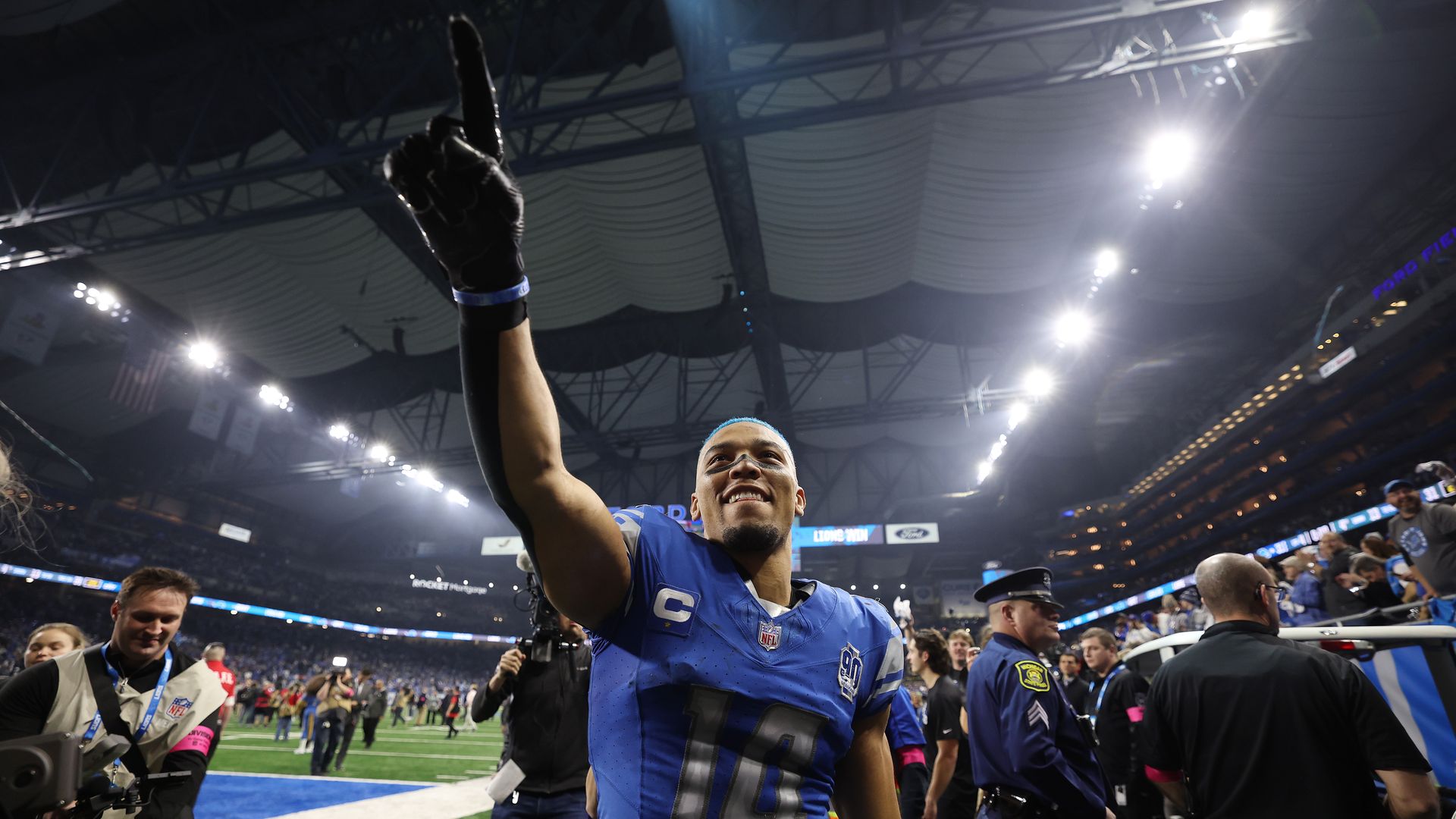 Amon-Ra St. Brown points to the crowd after beating the Tampa Bay Bucs 