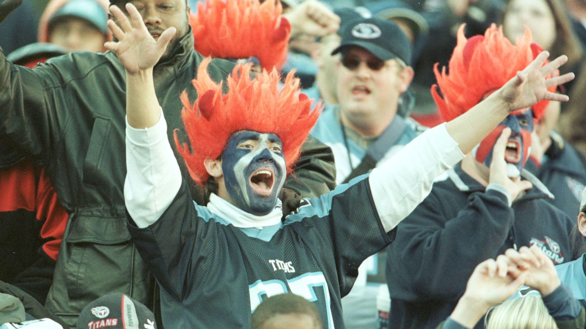 A fan cheers at a Titans game during the team's first season  at what is now Nissan Stadium. 