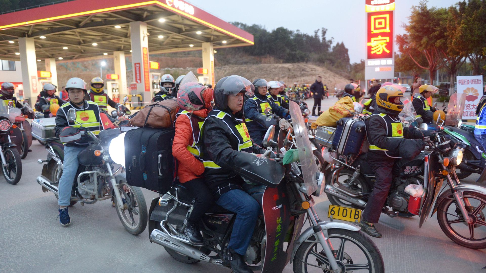 migrant workers ride motorcycles in Quanzhou City, southeast China's Fujian Province, Jan. 15, 2020.