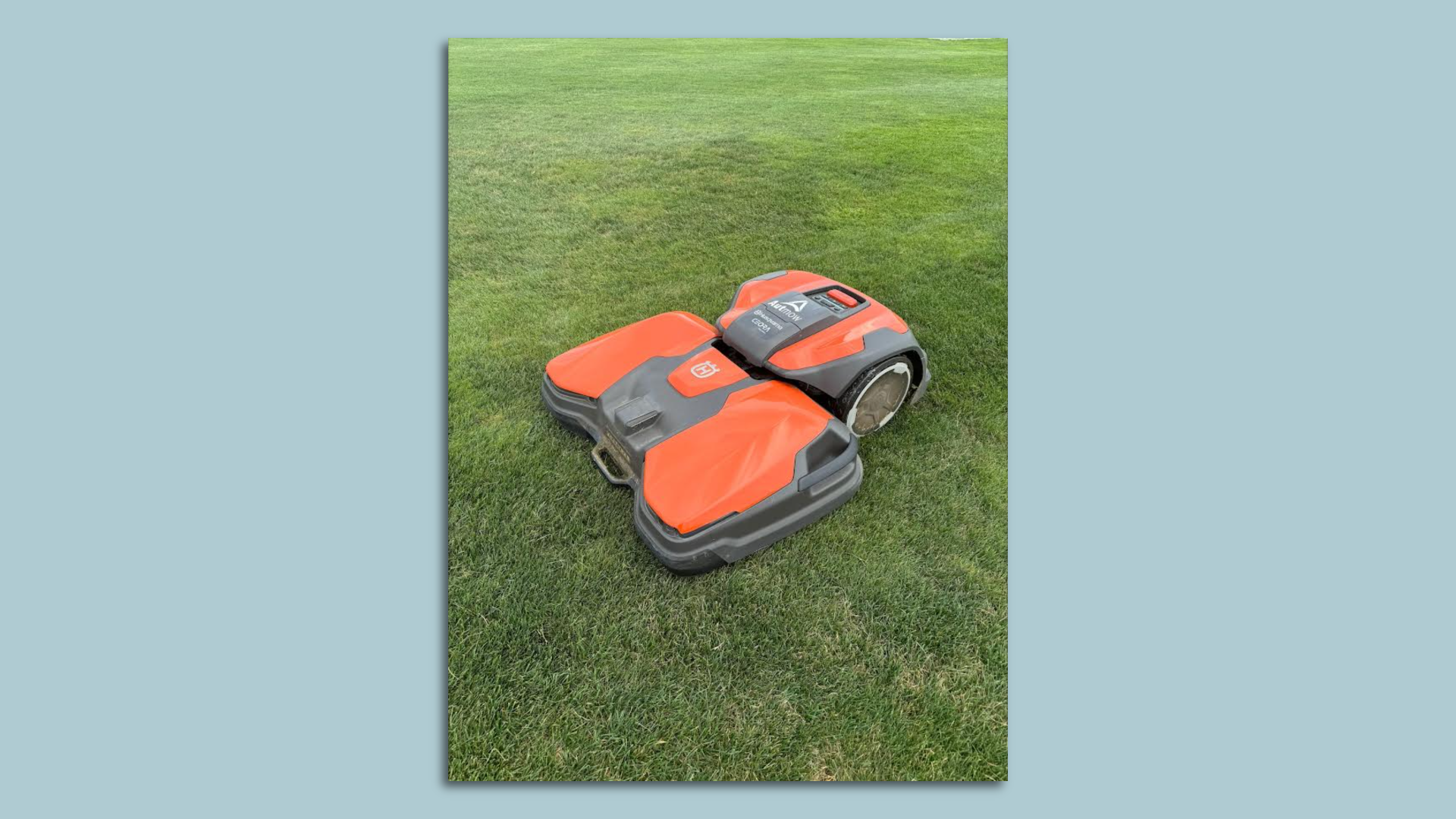 An autonomous lawn mower on the grass. 