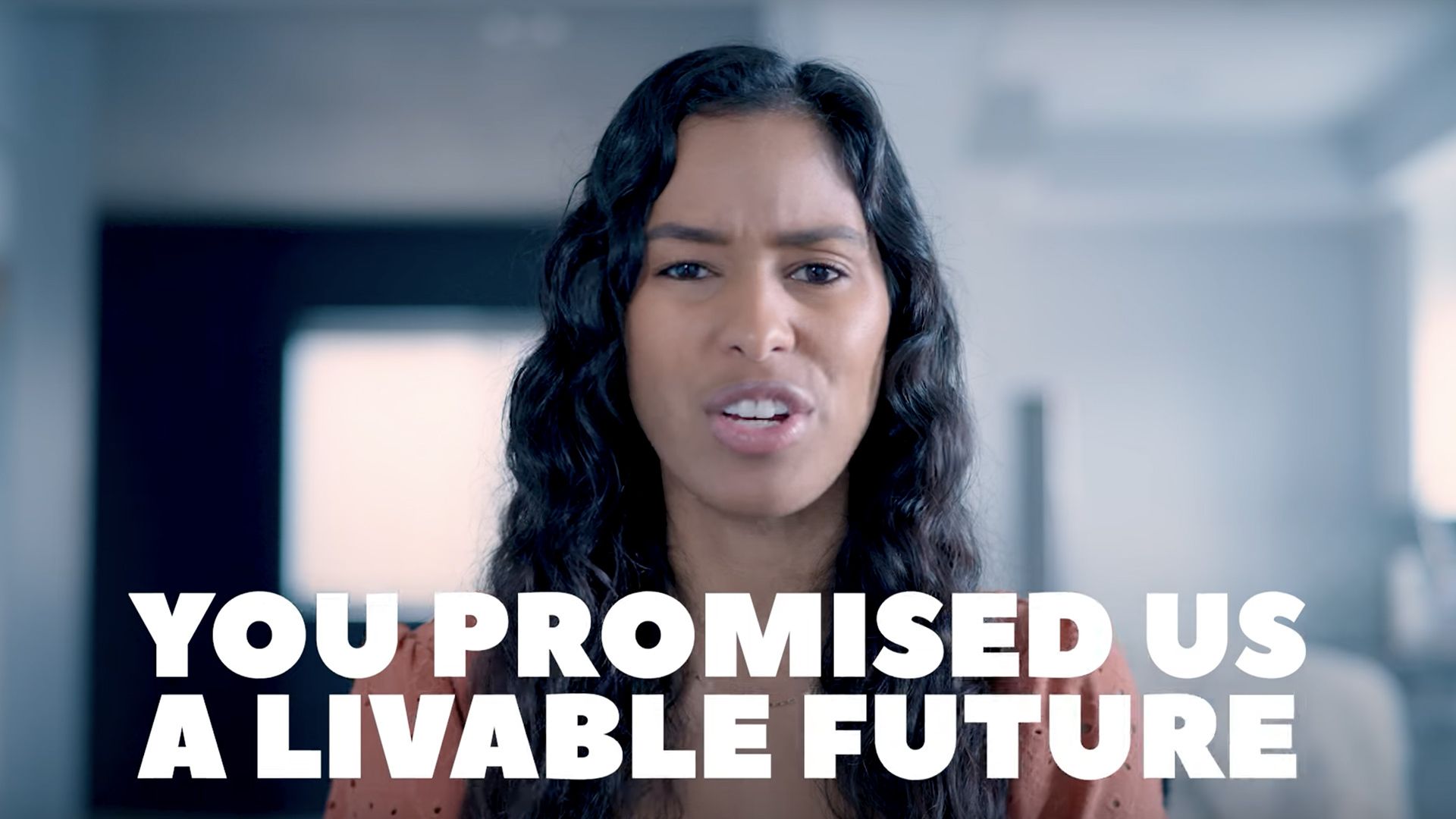 A young person speaks to the camera during a political advertisement about Joe Biden's climate policies.