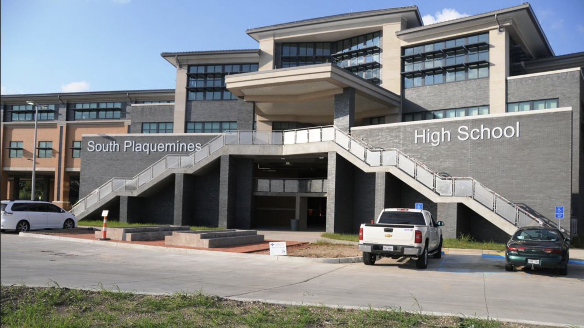 Image shows a school building with "South Plaquemines High School" written on it.
