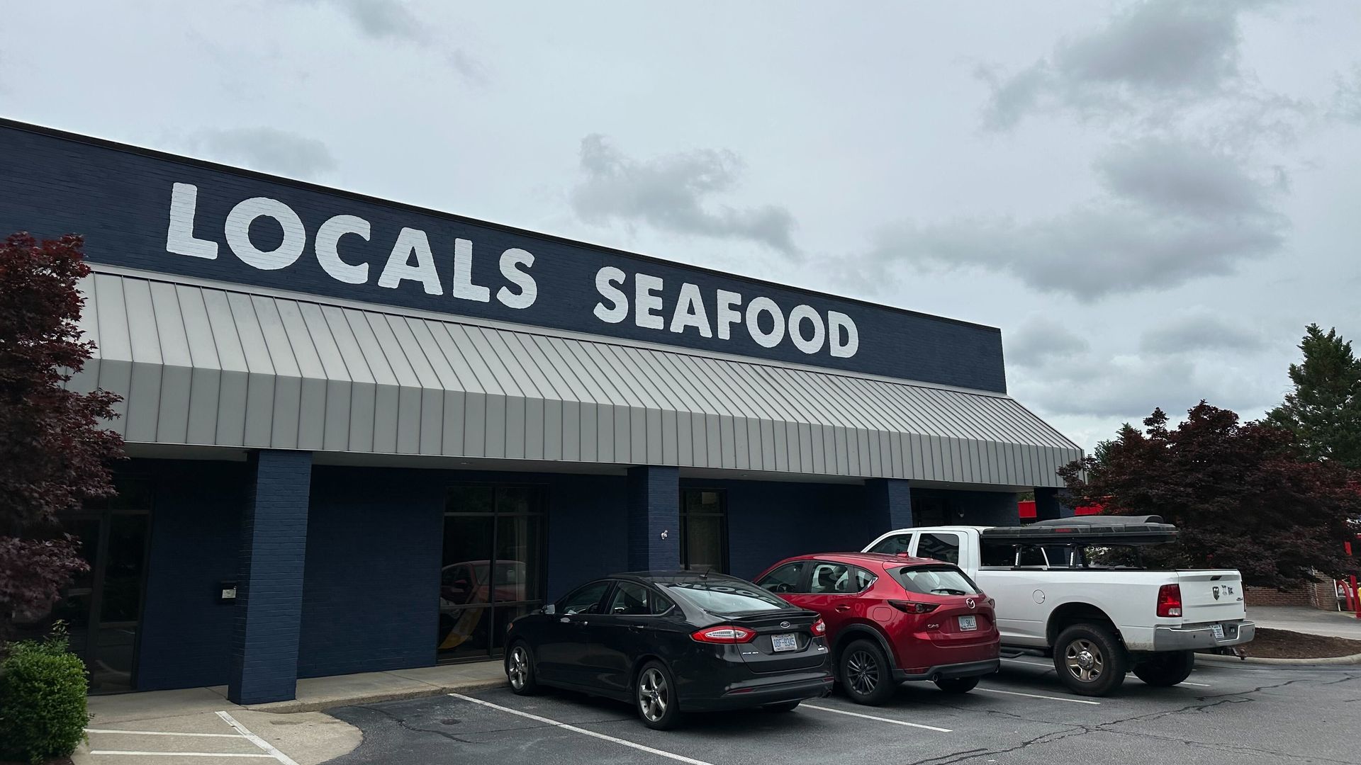 A storefront that says Locals Seafood on it