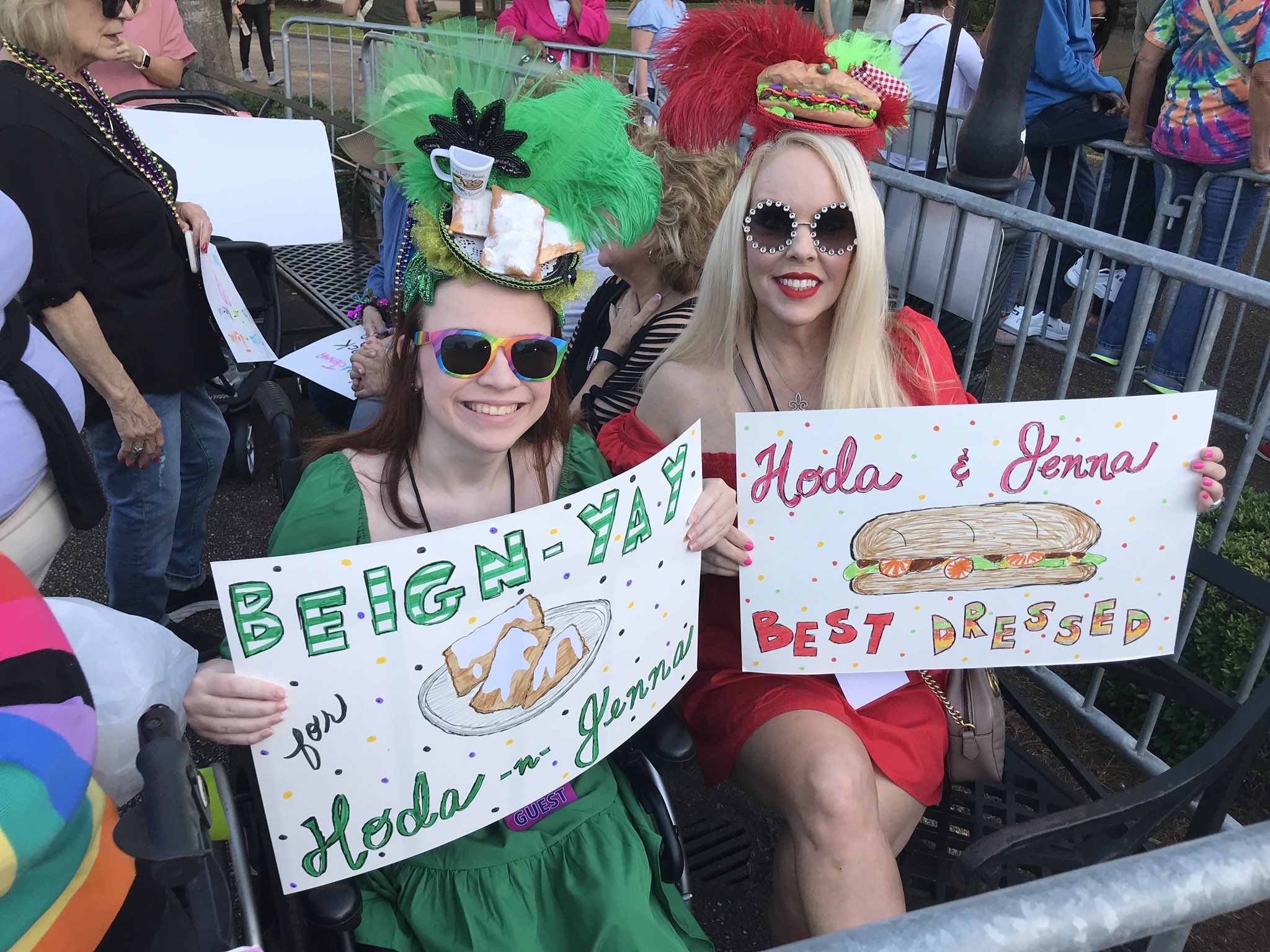 Photo shows two women dressed as beignets and poboys. They are holding signs that say "Beign-yay for Hoda n Jenna" and "Hoda & Jenna best dressed"