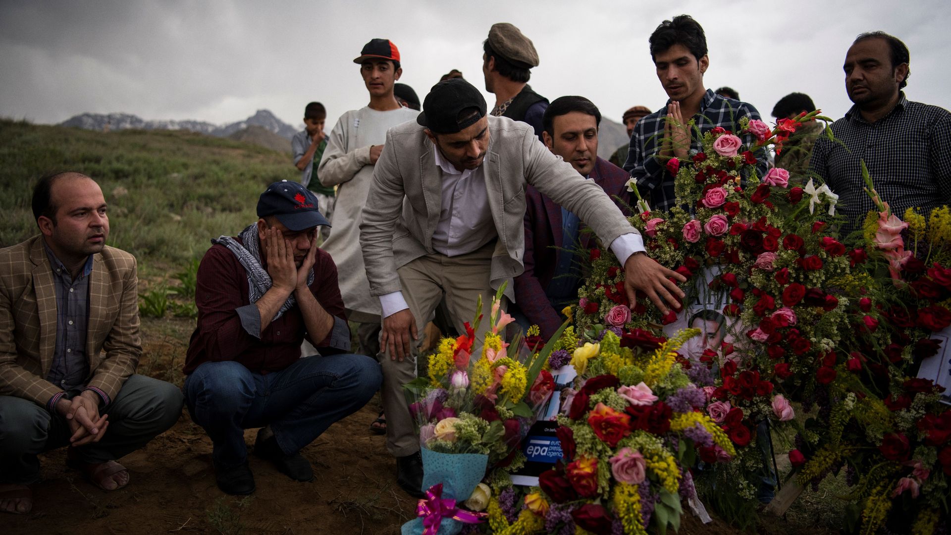 Friends and relatives of Agence France Presse Afghanistan Chief Photographer Shah Marai Faizi gather at his burial in Gul Dara, Kabul on April 30, 2018.