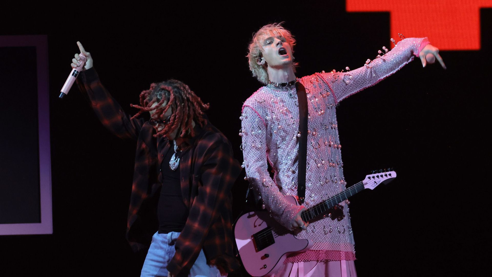 Rapperes Trippie Redd and Machine Gun Kelly perform on stage. 