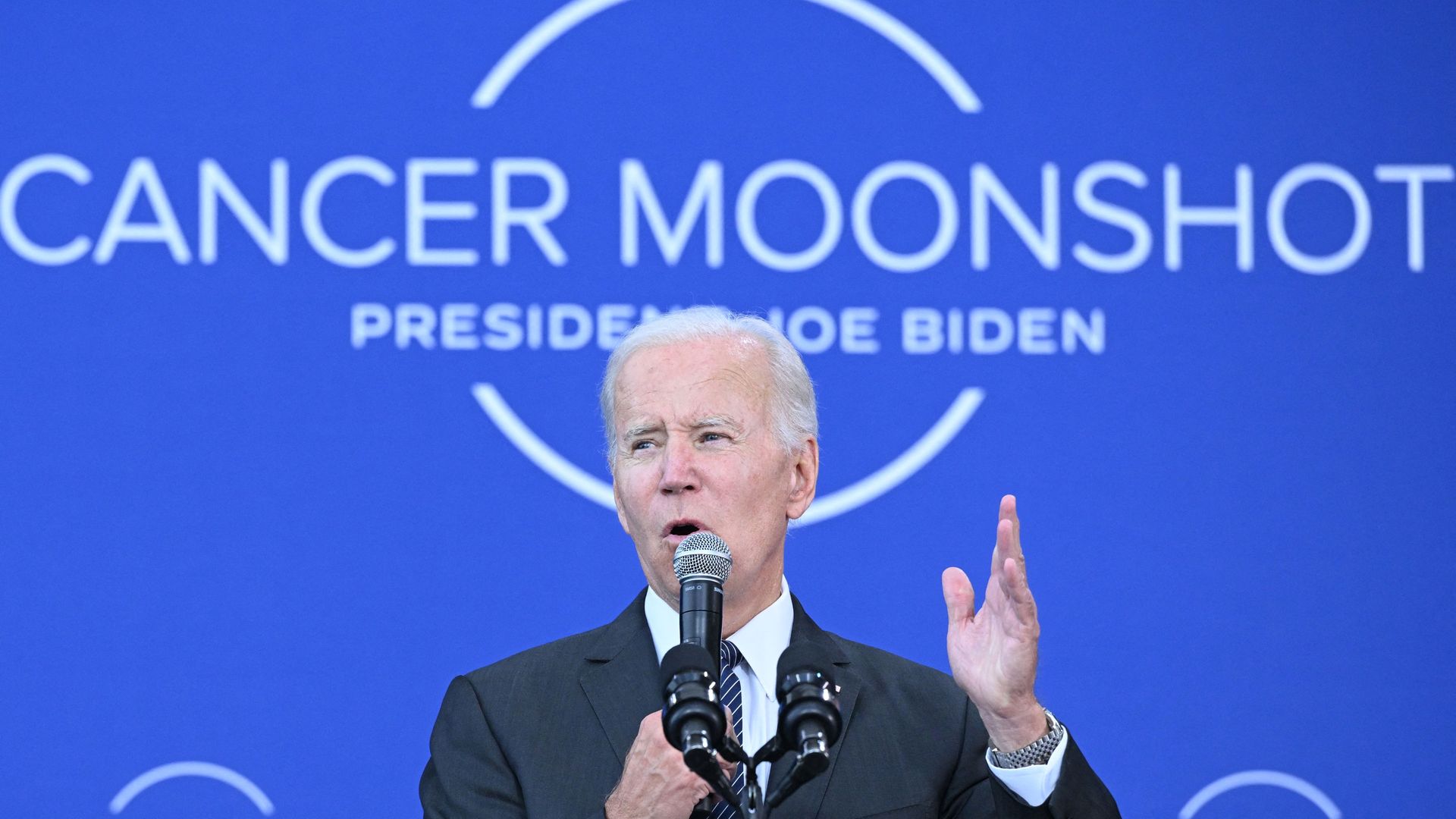 Photo shows President Joe Biden in front of a blue background that says "Cancer Moonshot."