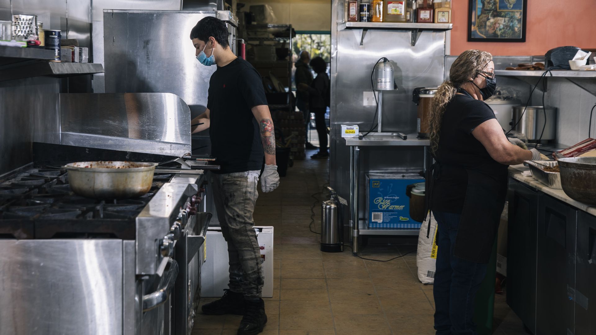 A man and woman are shown cooking at a Puerto Rico restaurant. 