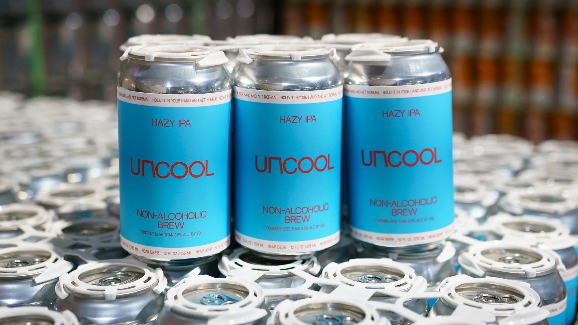 A six-pack of Uncool nonalcoholic beer in blue cans