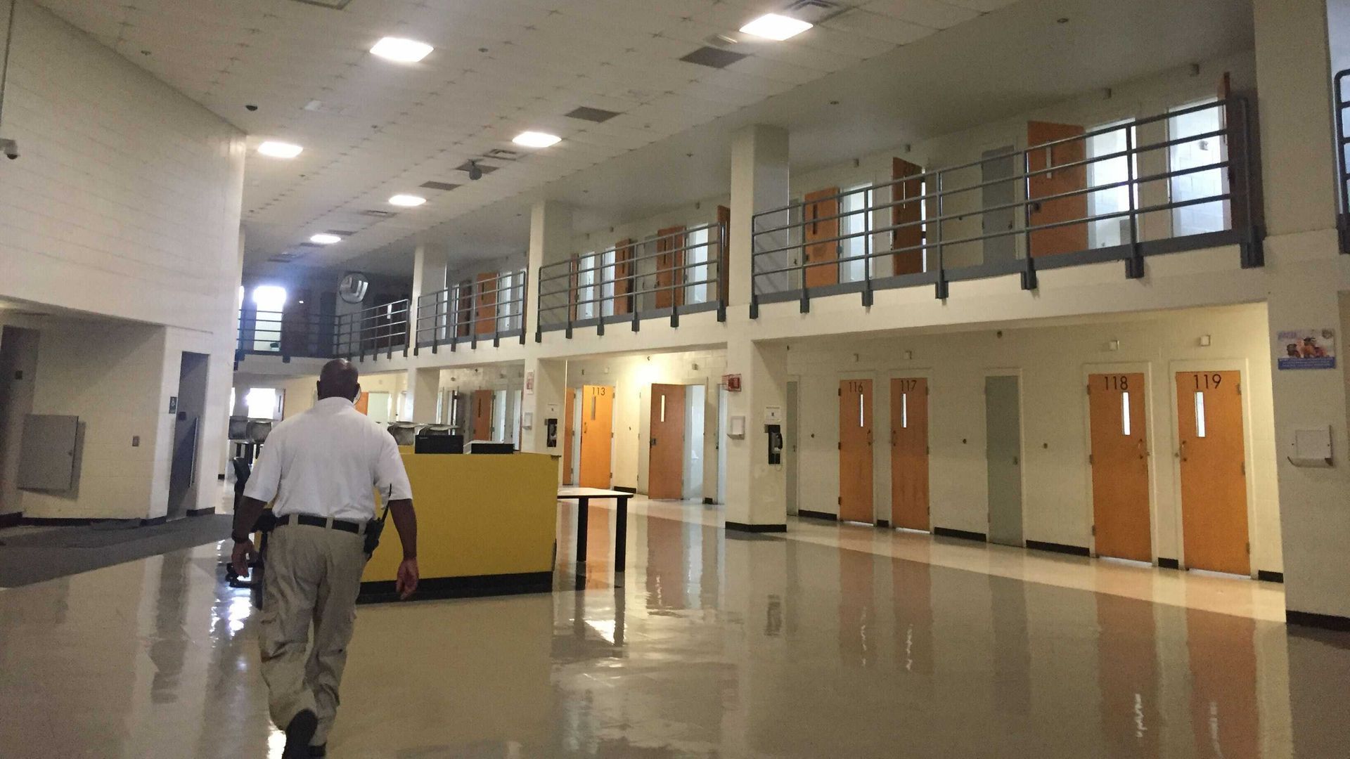 A man walks in a bright and empty cell block in the Atlanta city jail