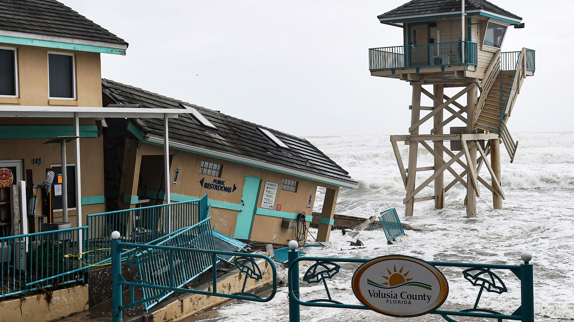 Waves crash near a damaged building and a lifeguard tower in Daytona Beach Shores in Florida, as tropical Storm Nicole approaches the coast.