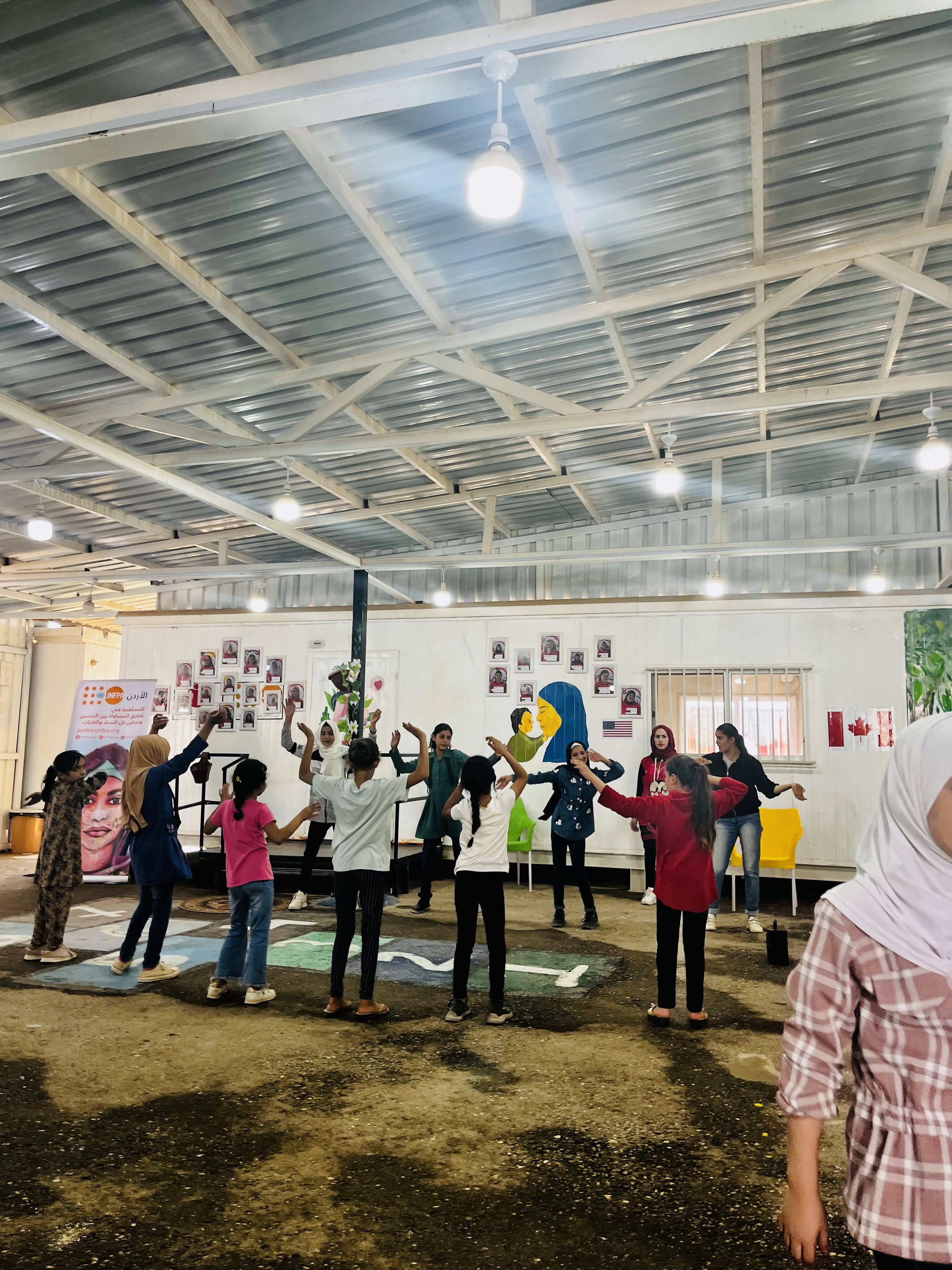 Syrian refugee girls practice Zumba at a center run by NGO Save the Children