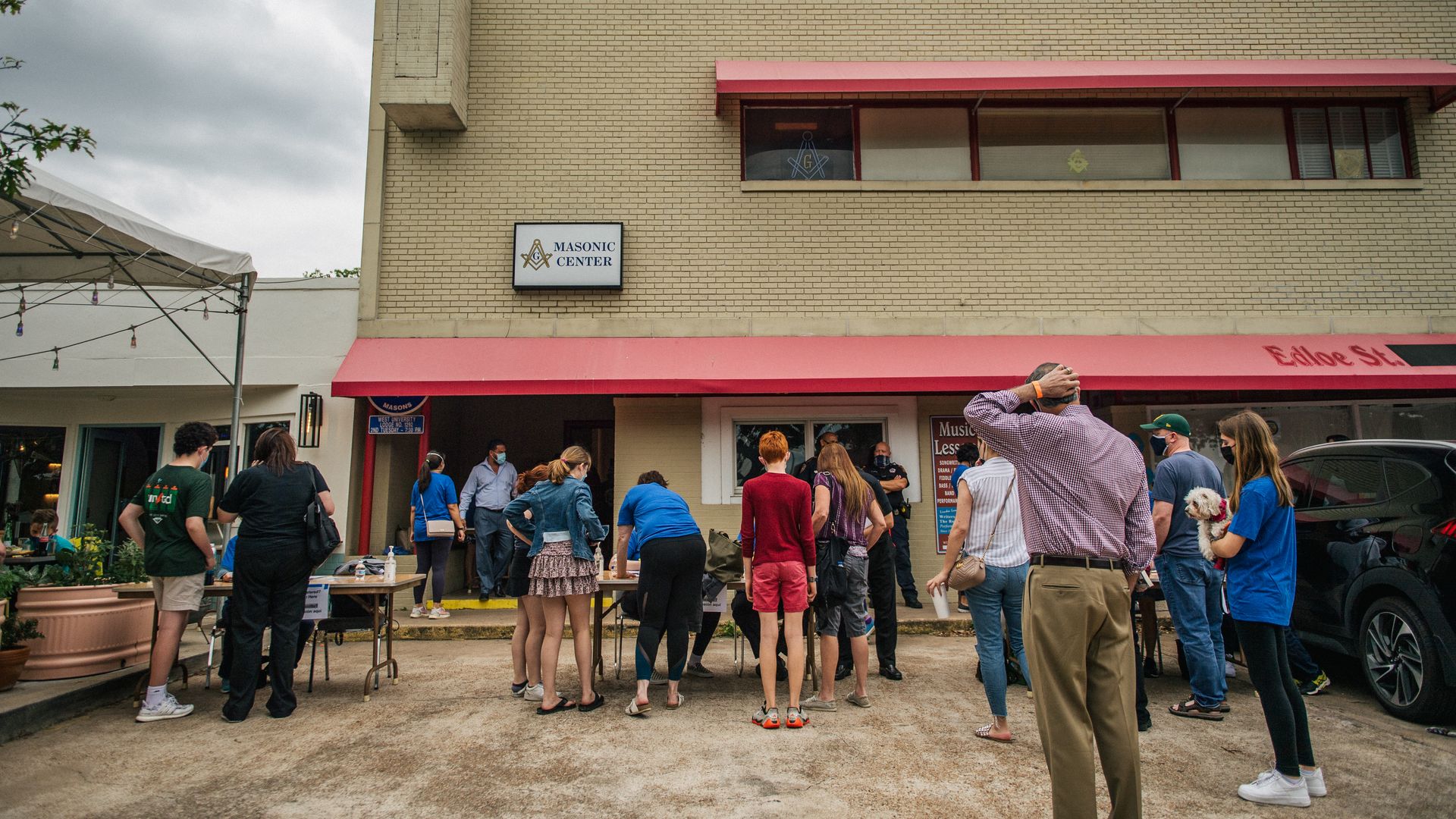 People wait and sign waivers ahead of a Covid-19 vaccine clinic in Houston.