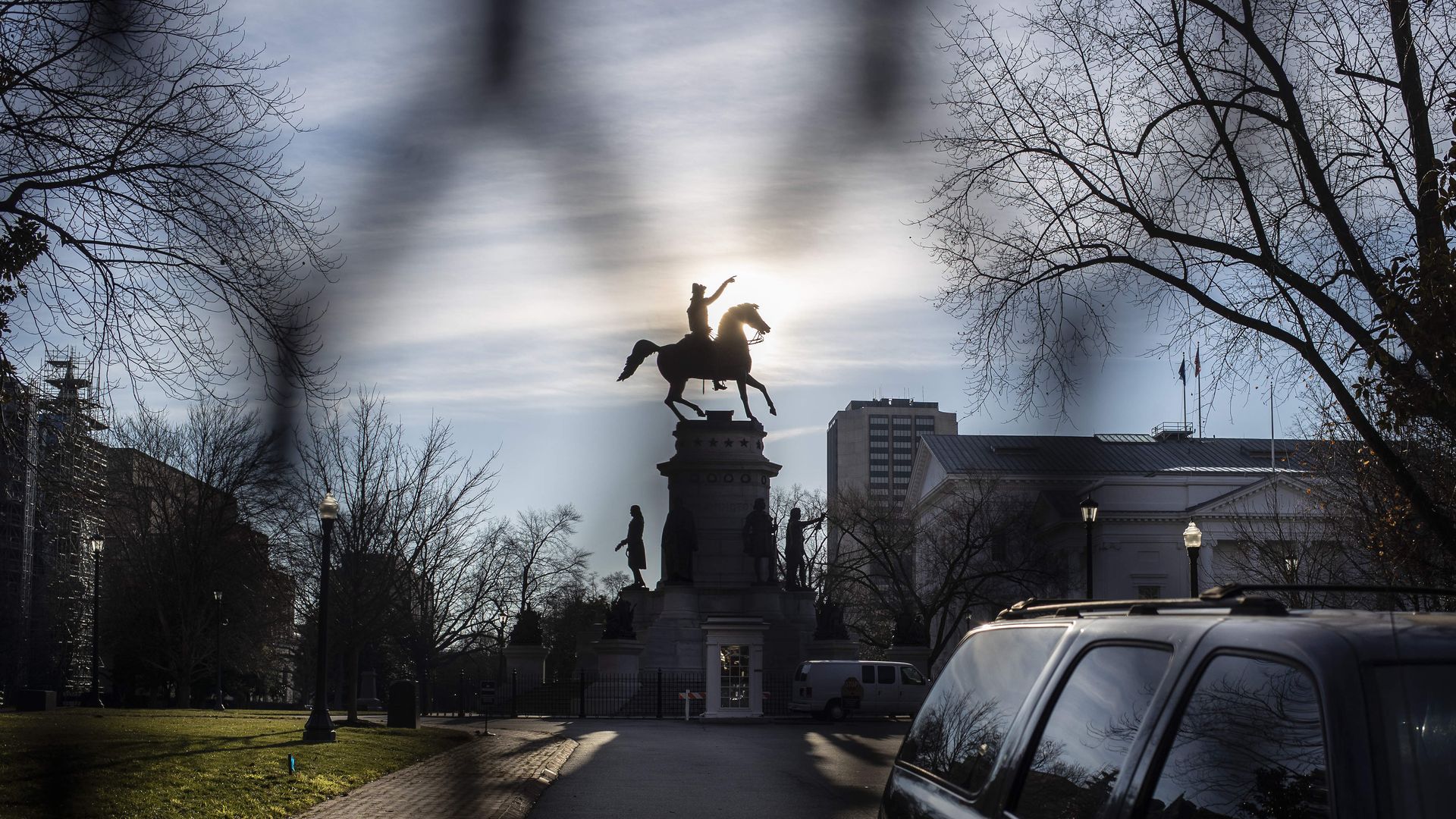 Photo of a statue in front of the Virginia State Capitol, photographed through a fence