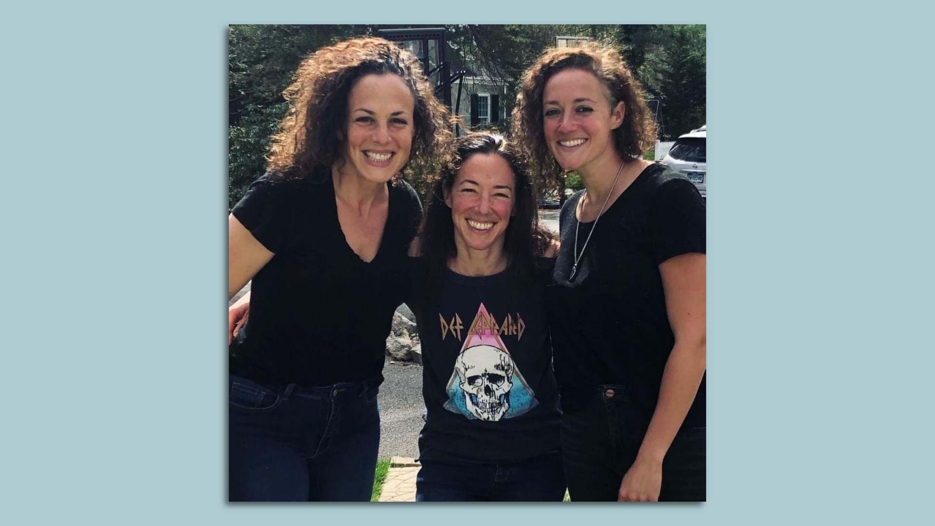 Sisters Naomi Giges Downey, Katy Ingulli and Melissa Giges embrace each other.