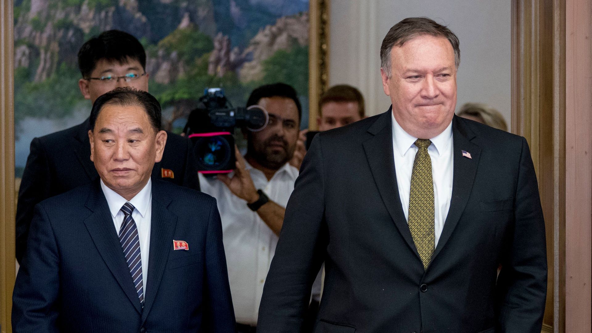 Mike Pompe and Kim Yong Chol walk into meeting room